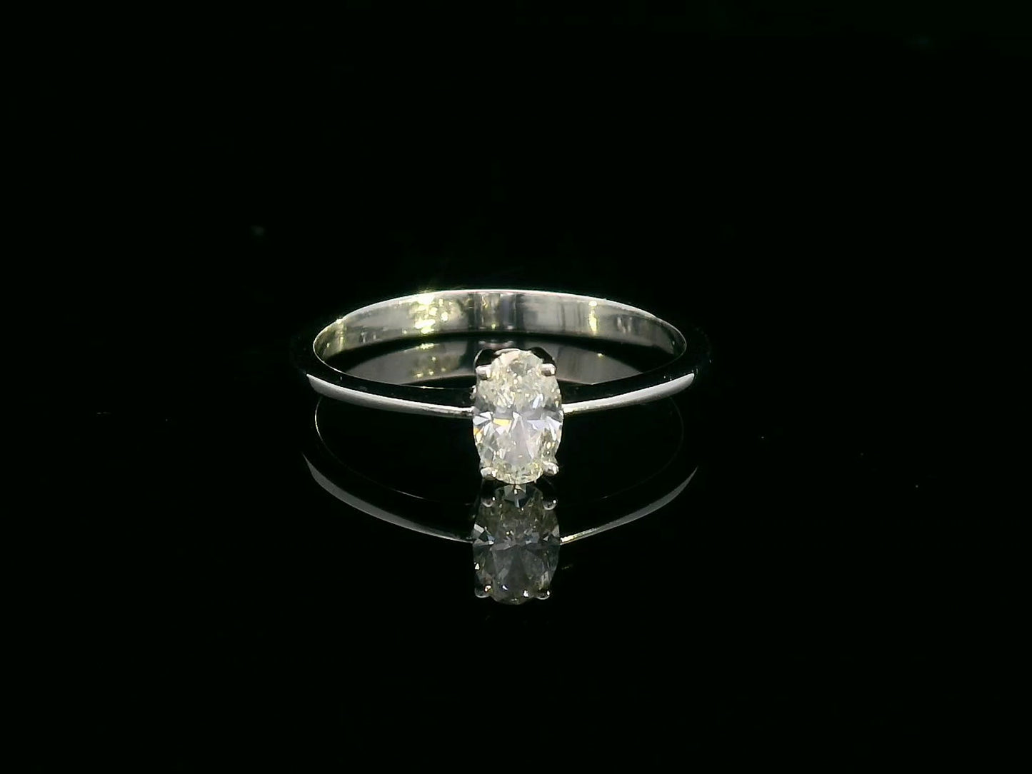 0.31 carat oval diamond solitaire ring in 18K white gold