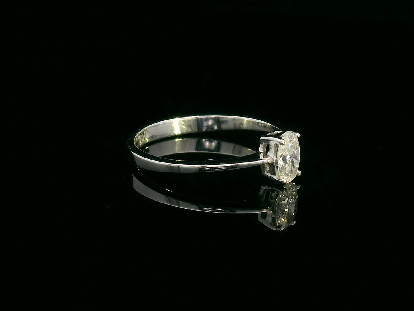 0.31 carat oval diamond solitaire ring in 18K white gold