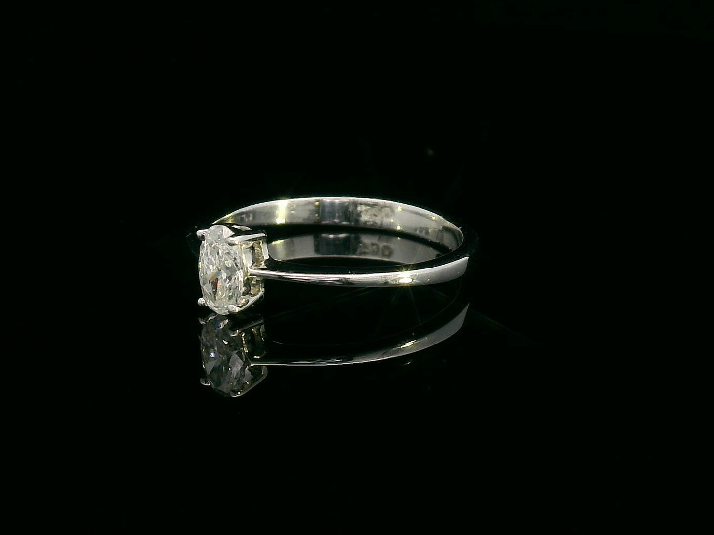 0.31 carat oval diamond solitaire ring in 18K white gold