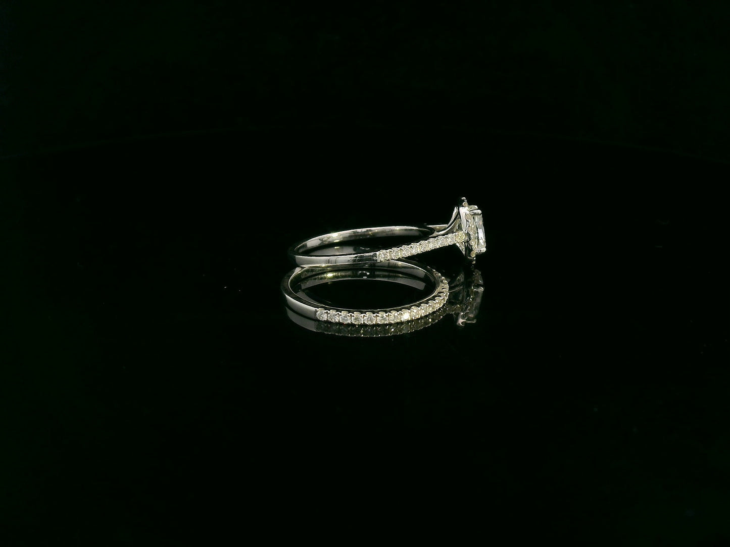 Cushion cut diamond bridal ring set in 18K white gold with diamond wedding band by Emirates Diamonds.