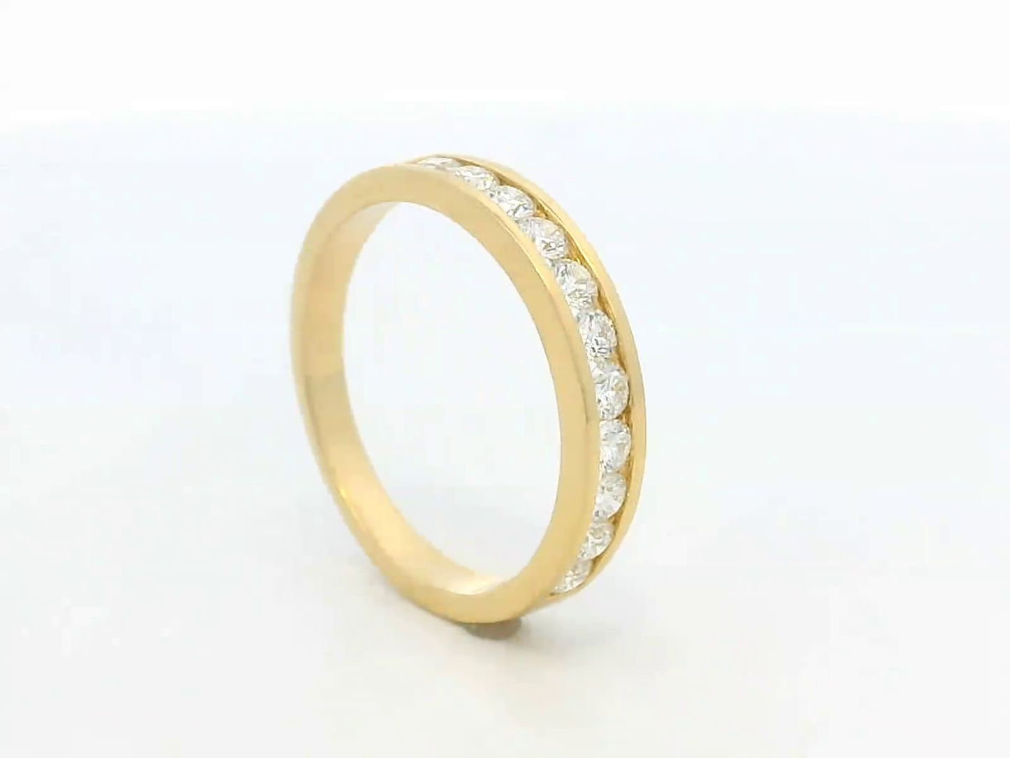 Elegant 18K yellow gold eternity band featuring 0.63ct channel-set round diamonds, perfect as a wedding, stacking, or anniversary ring.