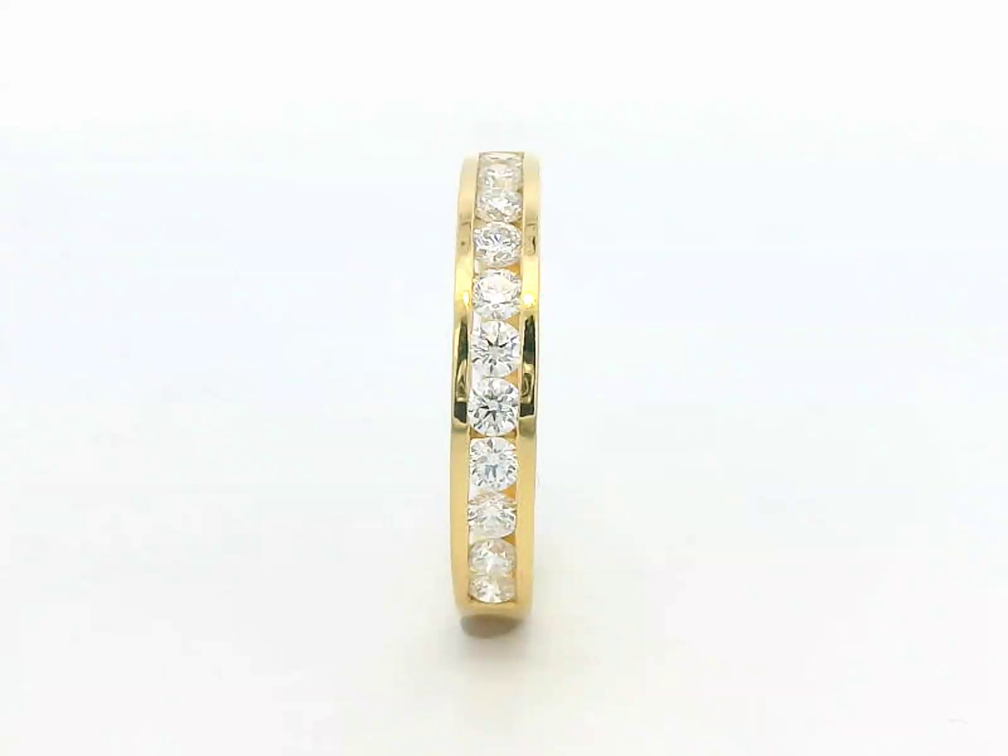 Elegant 18K yellow gold eternity band featuring 0.63ct channel-set round diamonds, perfect as a wedding, stacking, or anniversary ring.