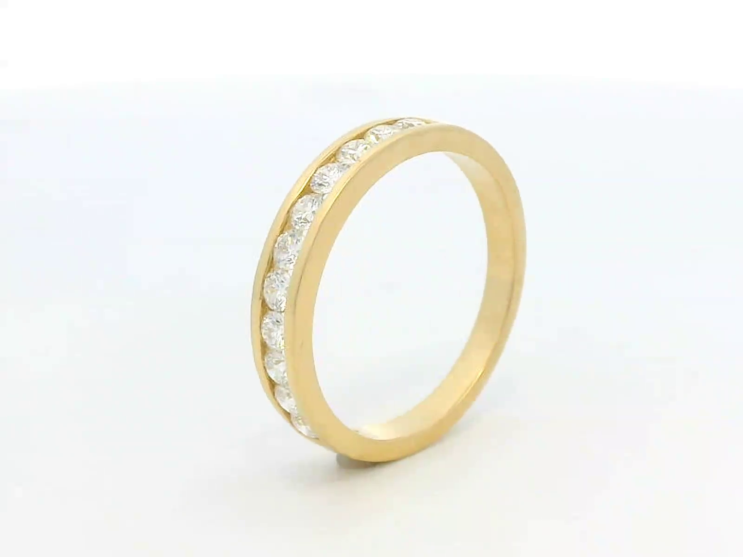 Elegant 18K yellow gold eternity band featuring 0.63ct channel-set round diamonds, perfect as a wedding, stacking, or anniversary ring.