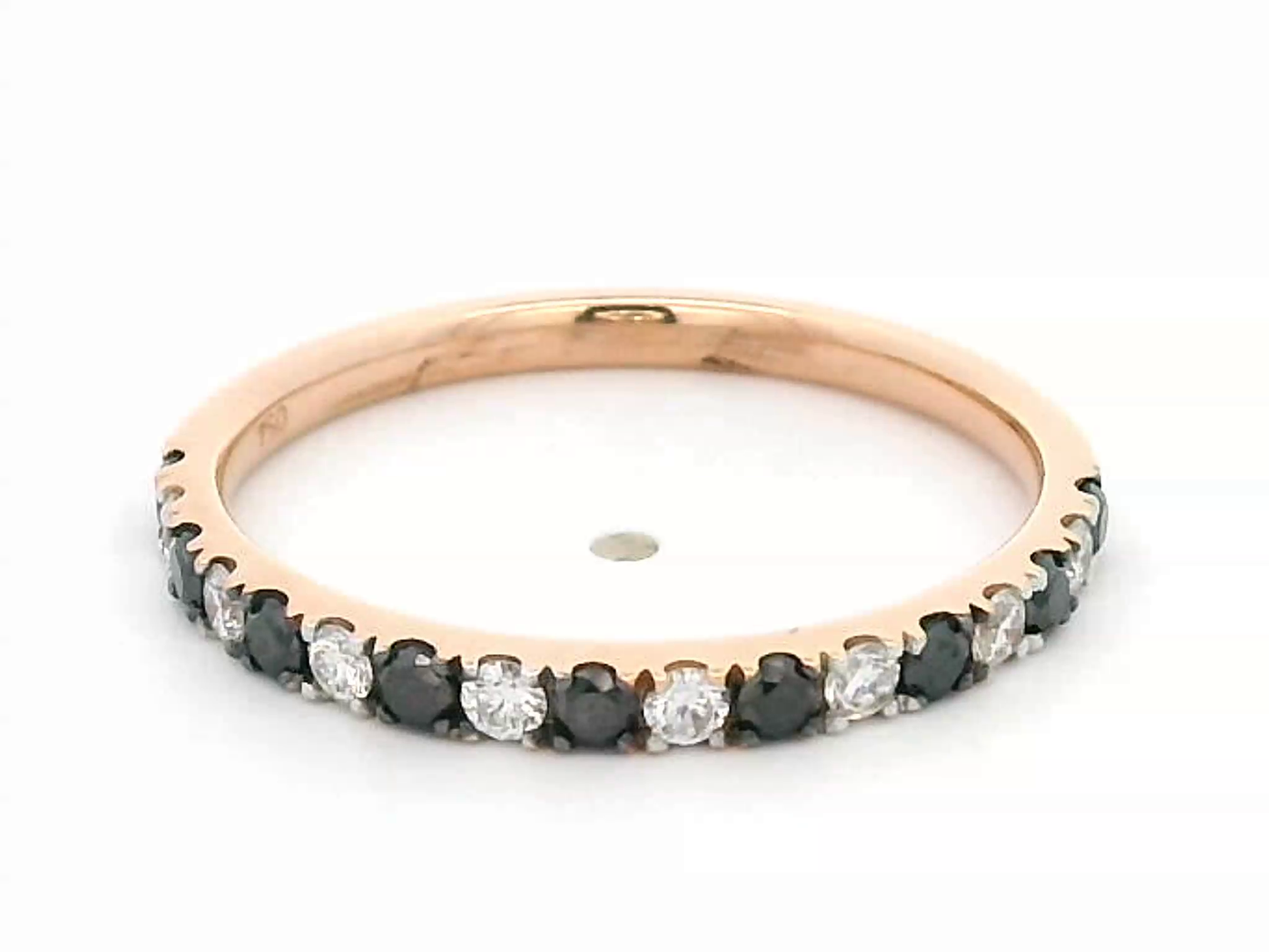 18K rose gold black and white diamond eternity ring featuring 0.45ct of diamonds in a half-eternity wedding band style, perfect for stacking or as a unique wedding ring.