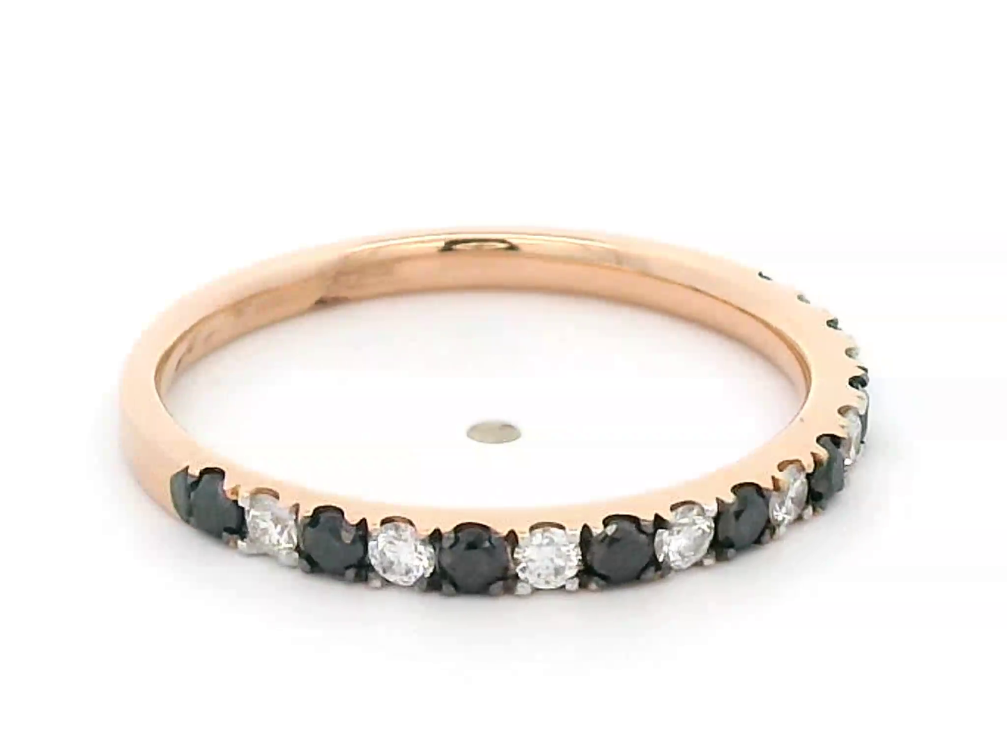 18K rose gold black and white diamond eternity ring featuring 0.45ct of diamonds in a half-eternity wedding band style, perfect for stacking or as a unique wedding ring.