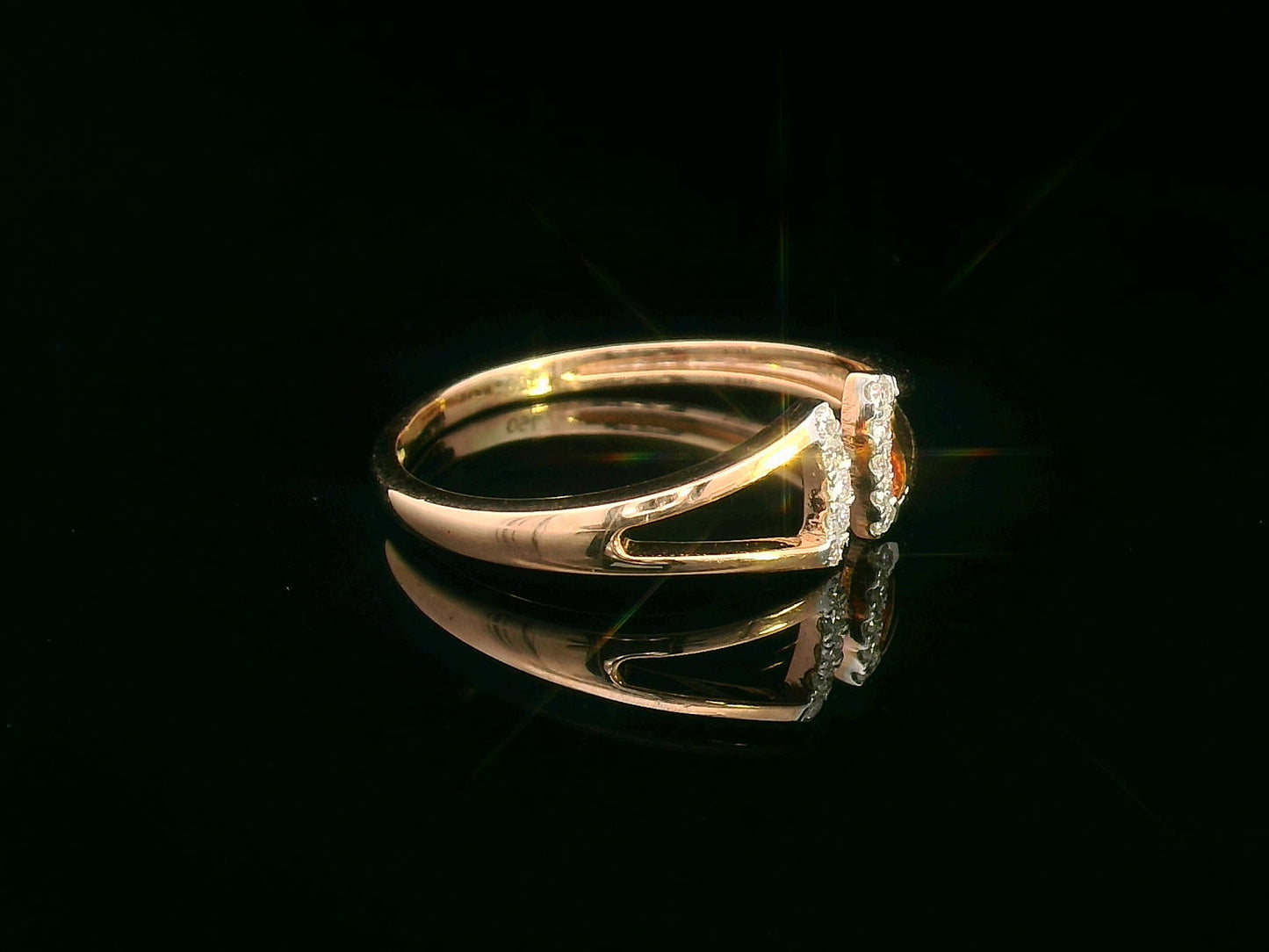 18K gold open-style ring with a geometric split shank and 0.07 carats of diamonds.