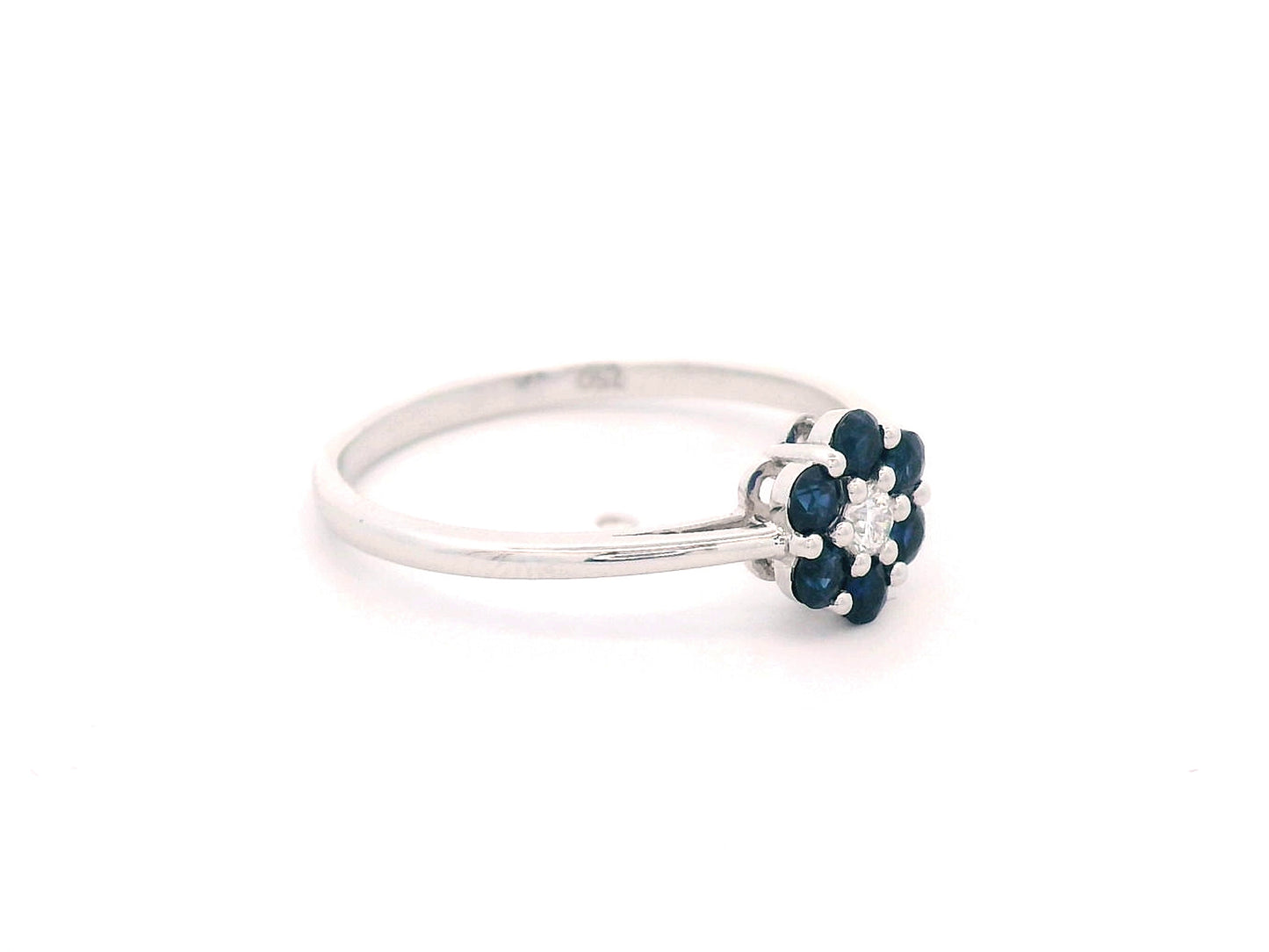 18K gold flower ring with 0.37ct blue sapphires and a 0.06ct diamond accent, designed in a delicate floral shape for timeless elegance.