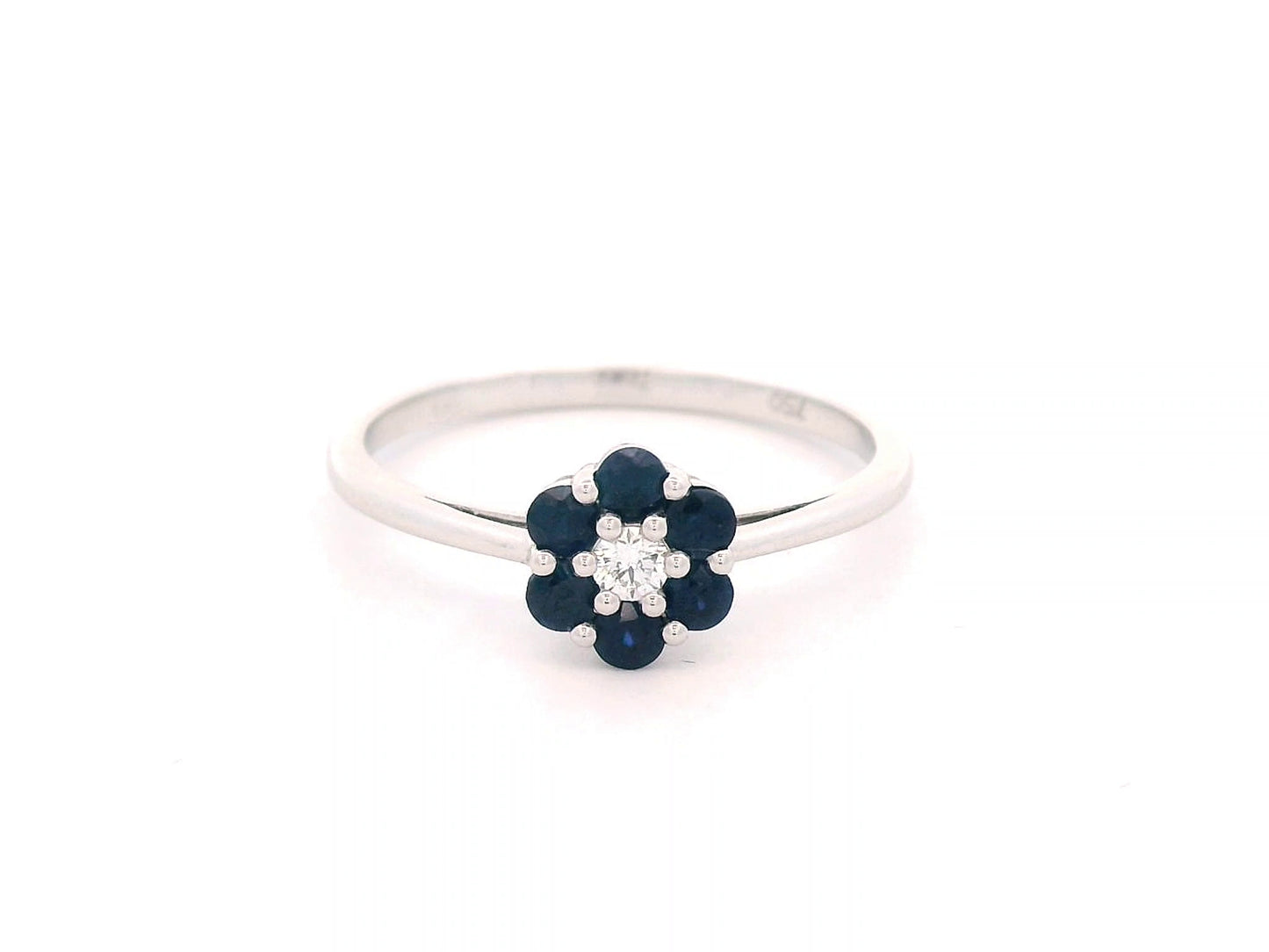 18K gold flower ring with 0.37ct blue sapphires and a 0.06ct diamond accent, designed in a delicate floral shape for timeless elegance.