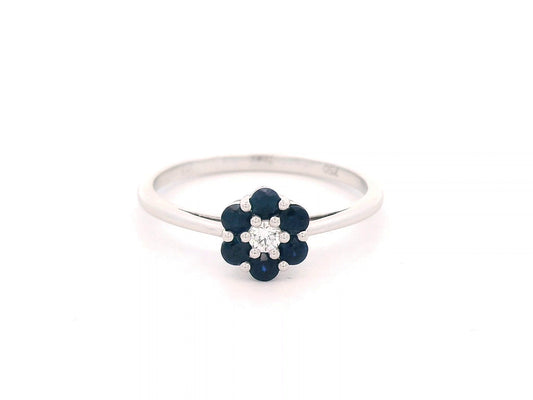 18K gold flower ring with 0.37ct blue sapphires and a 0.06ct diamond accent, designed in a delicate floral shape for timeless elegance.