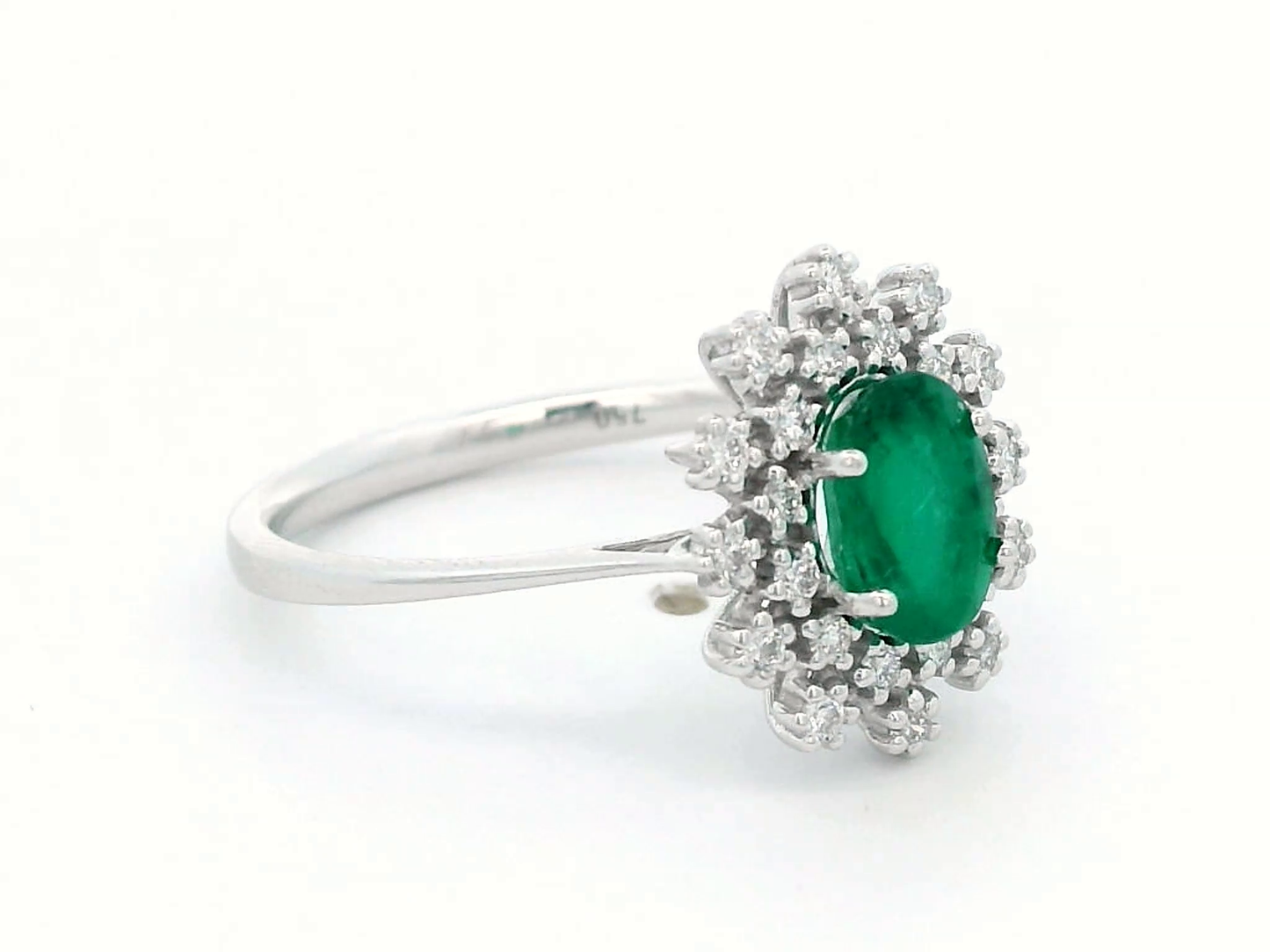 18K white gold emerald and diamond halo ring featuring a 0.92 carat oval emerald and 0.25 carat diamond cluster – fine jewelry by Emirates Diamonds