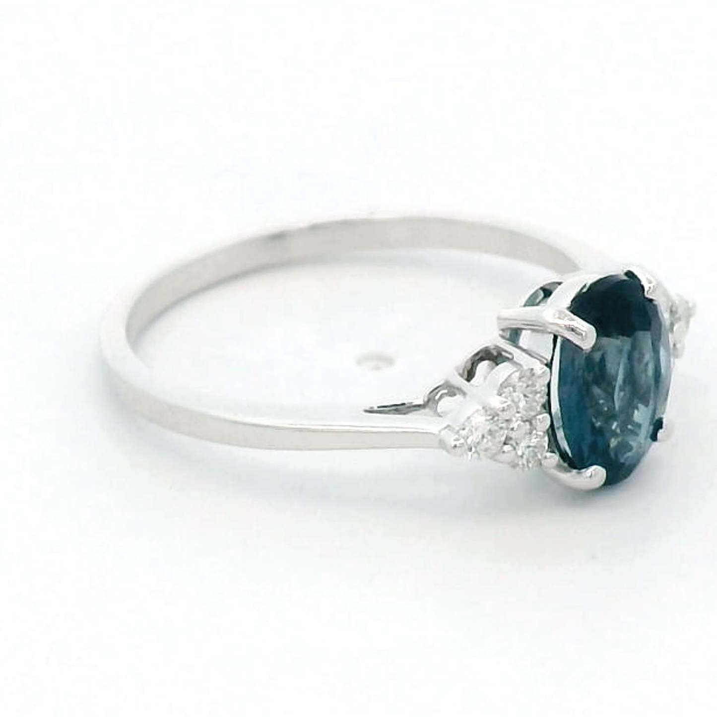 18K gold London Blue Topaz and diamond ring with a 1.30-carat oval-cut gemstone and 0.17 carats of round diamonds in a classic setting. Perfect blue gemstone ring for women.