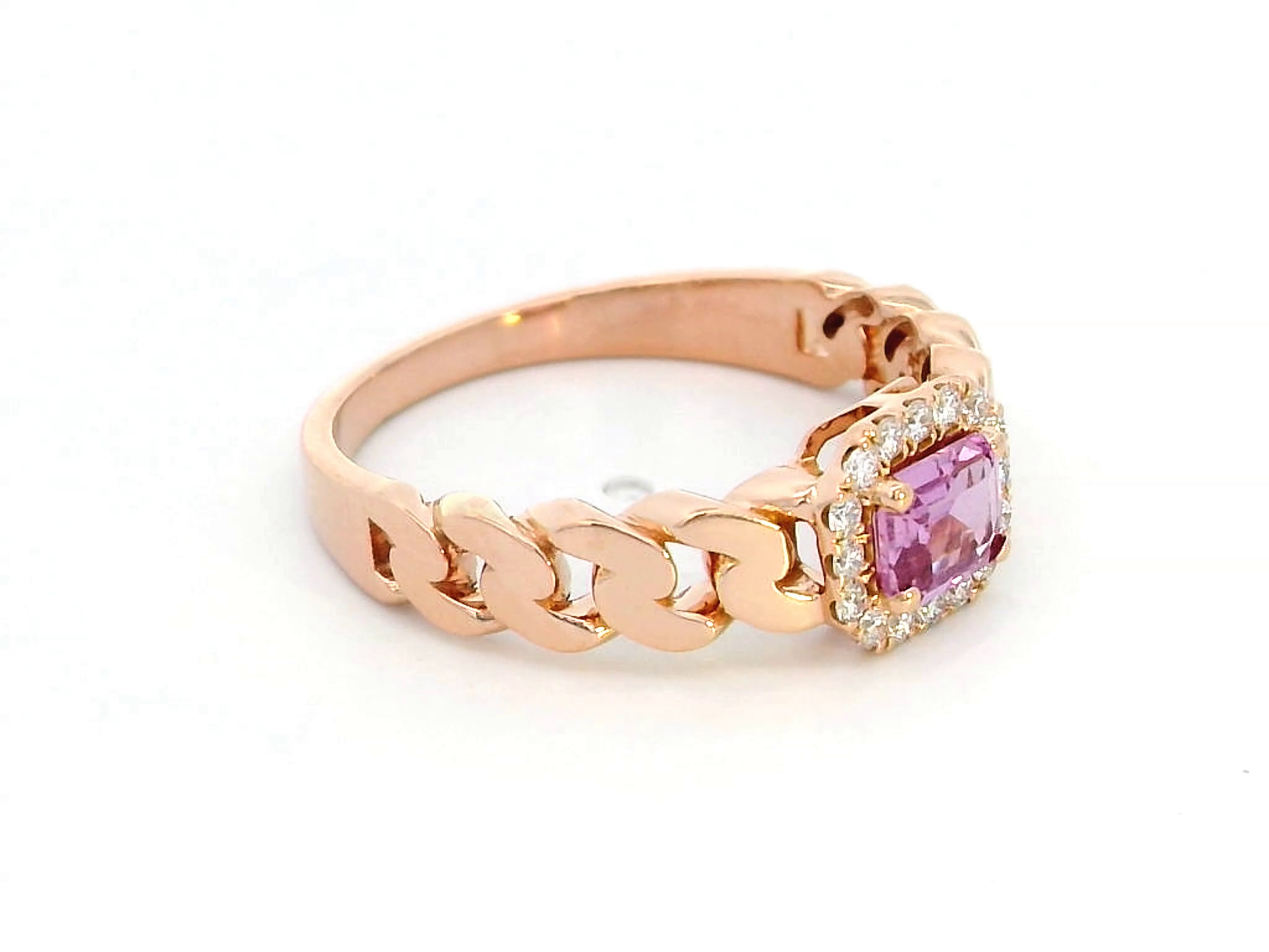 Elegant 18K gold pink sapphire and diamond halo ring with a 0.50-carat emerald-cut pink sapphire, surrounded by 0.14-carat round diamonds and a chain-link band design.