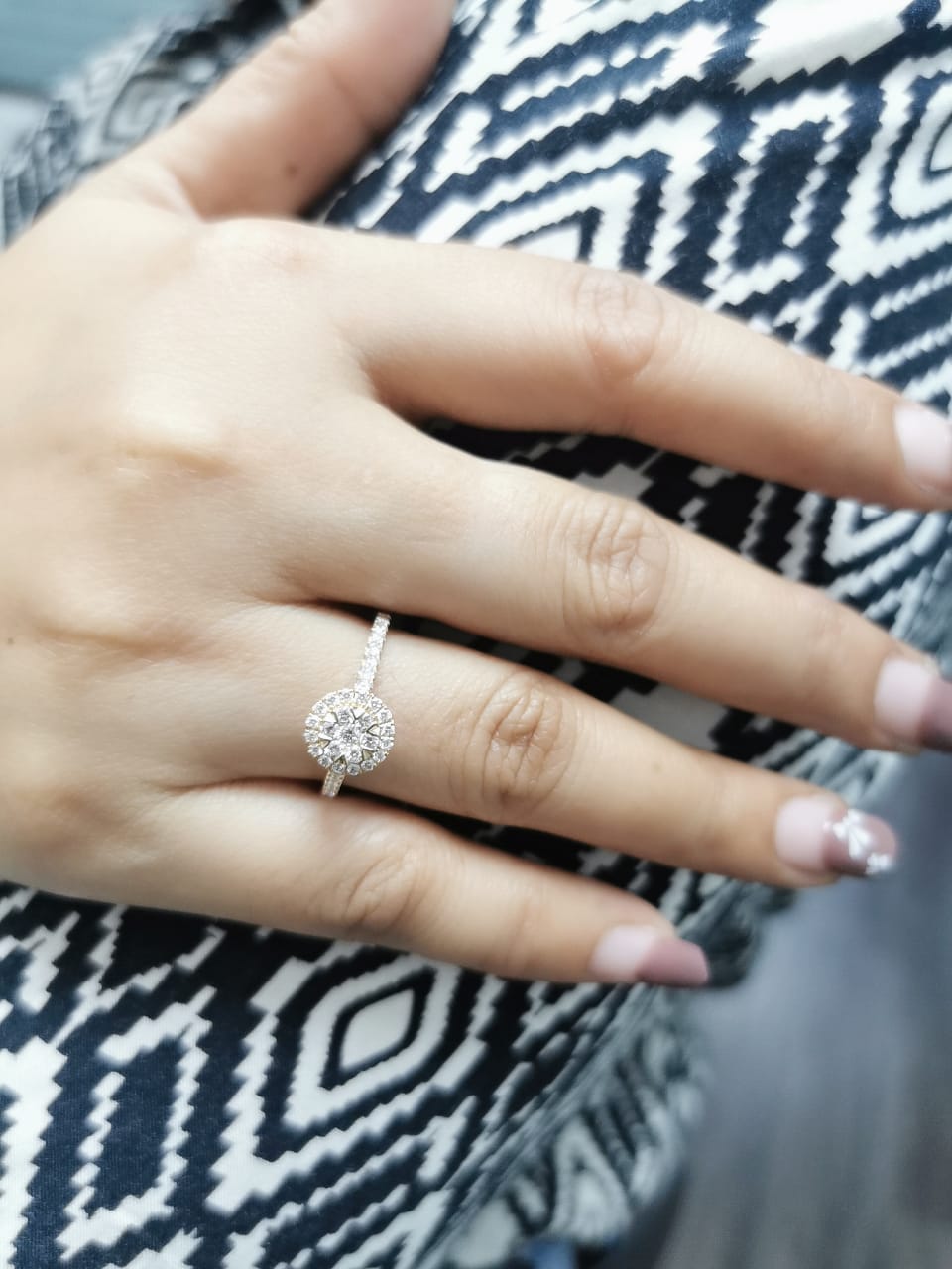 Luxury 18K yellow gold diamond cluster ring, featuring 0.61 carats of round-cut diamonds in a floral-inspired vintage design.