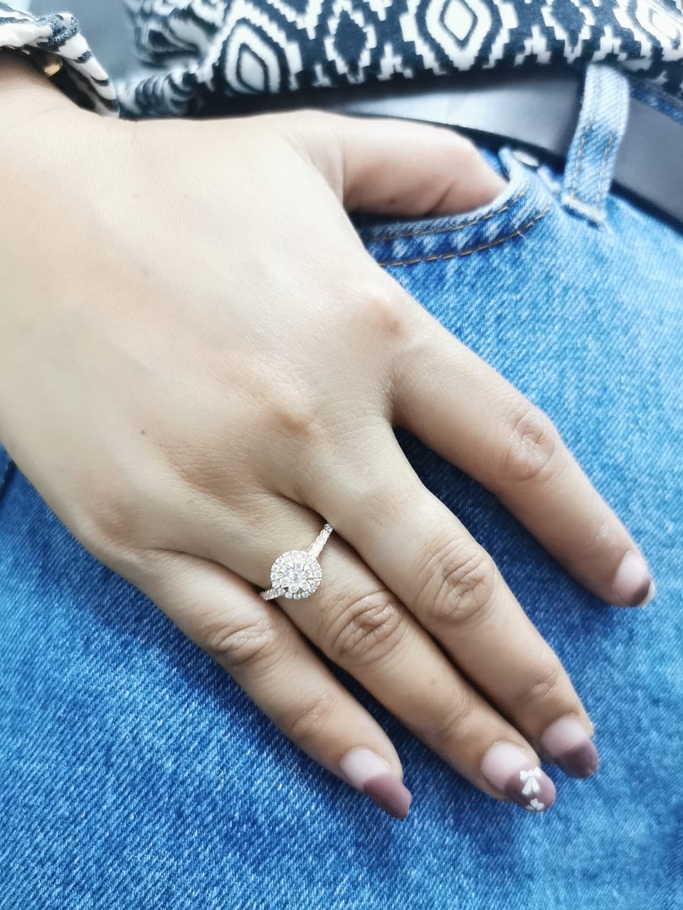 Luxury 18K yellow gold diamond cluster ring, featuring 0.61 carats of round-cut diamonds in a floral-inspired vintage design.