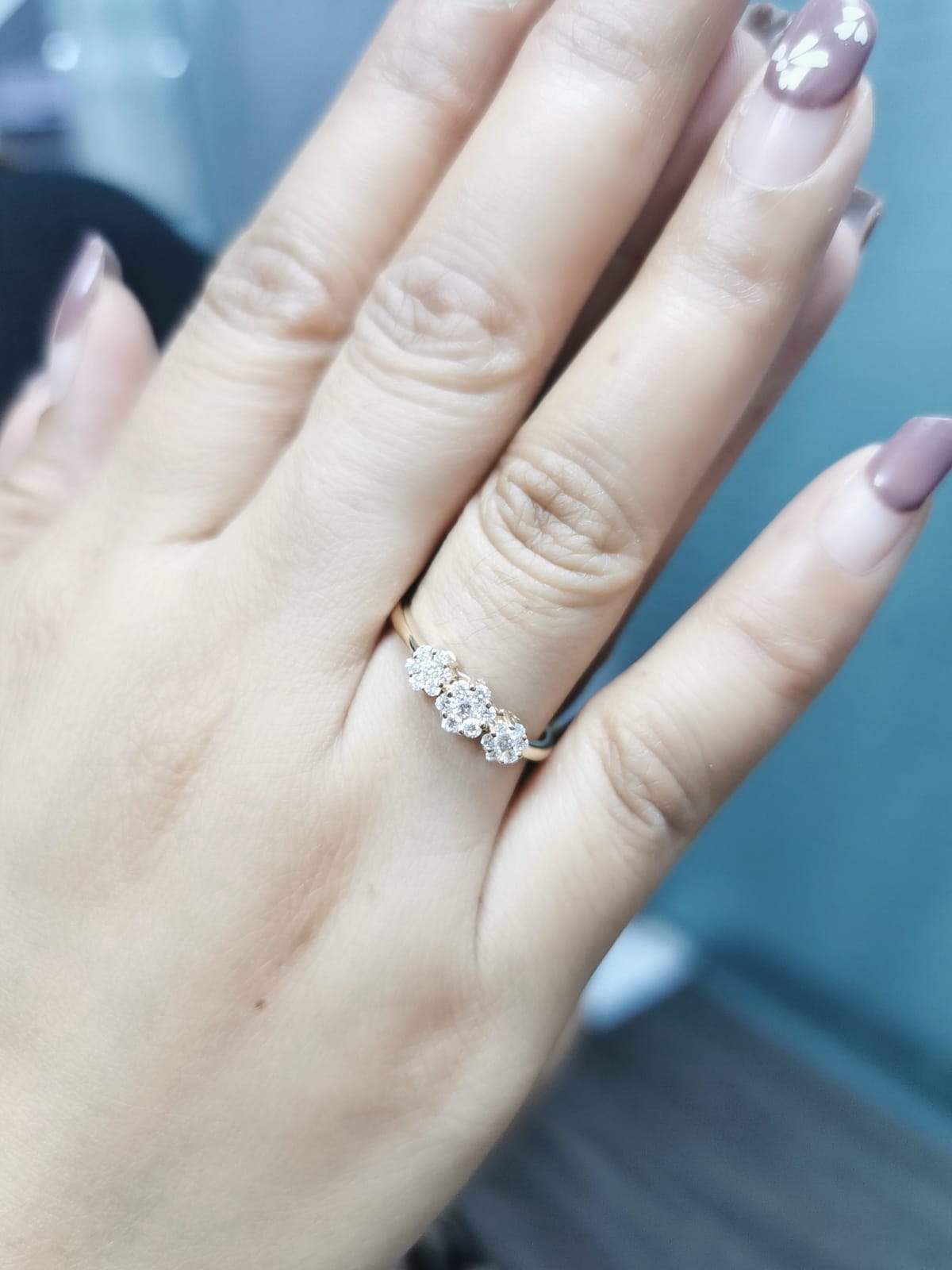 18k gold triple cluster diamond ring featuring 0.37 carat diamonds in a floral design.