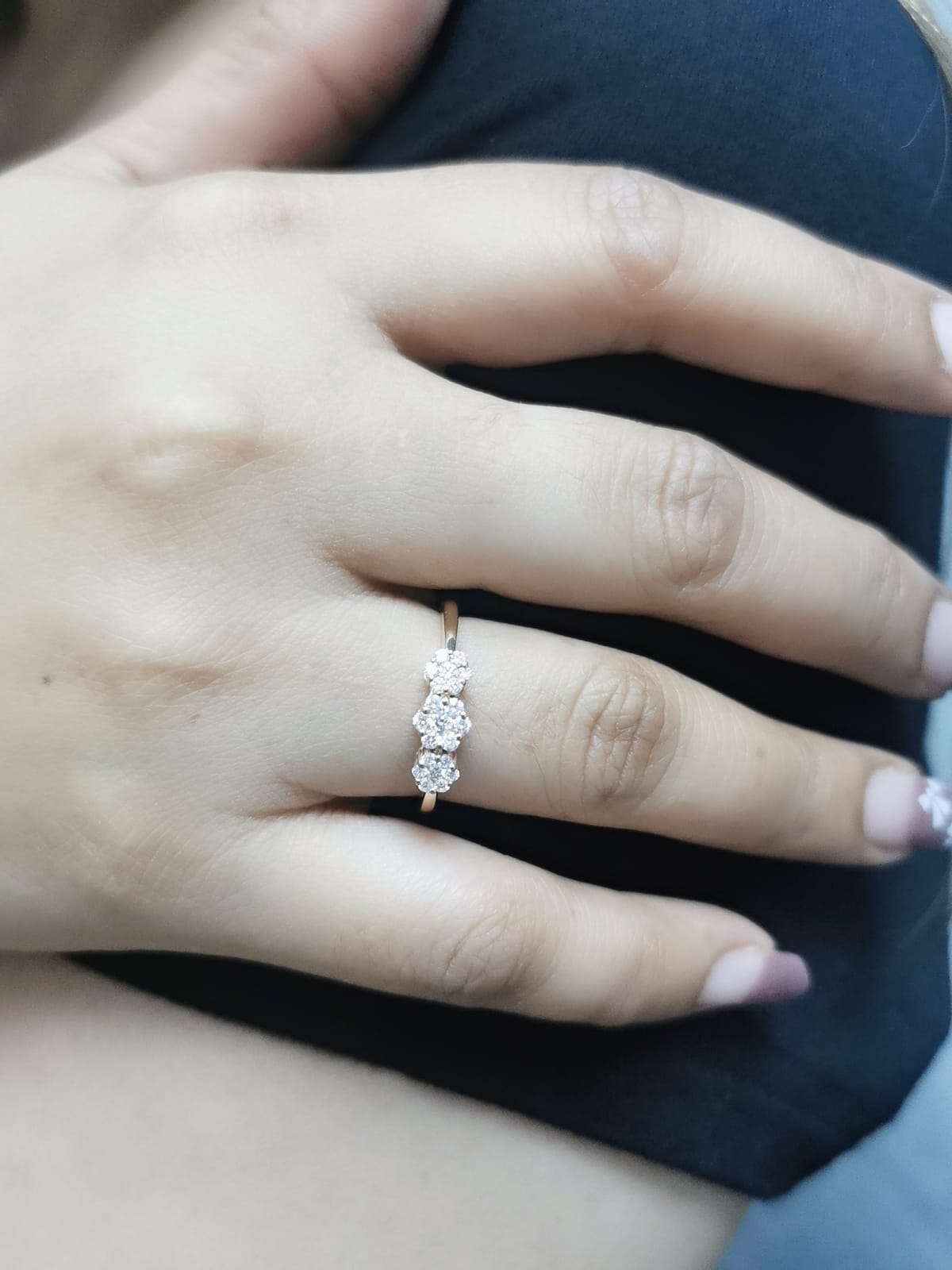 18k gold triple cluster diamond ring featuring 0.37 carat diamonds in a floral design.