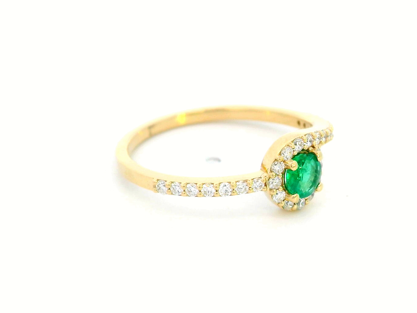 18K yellow gold halo ring featuring a 0.22-carat round emerald surrounded by 0.25-carat diamonds on a diamond-accented band.