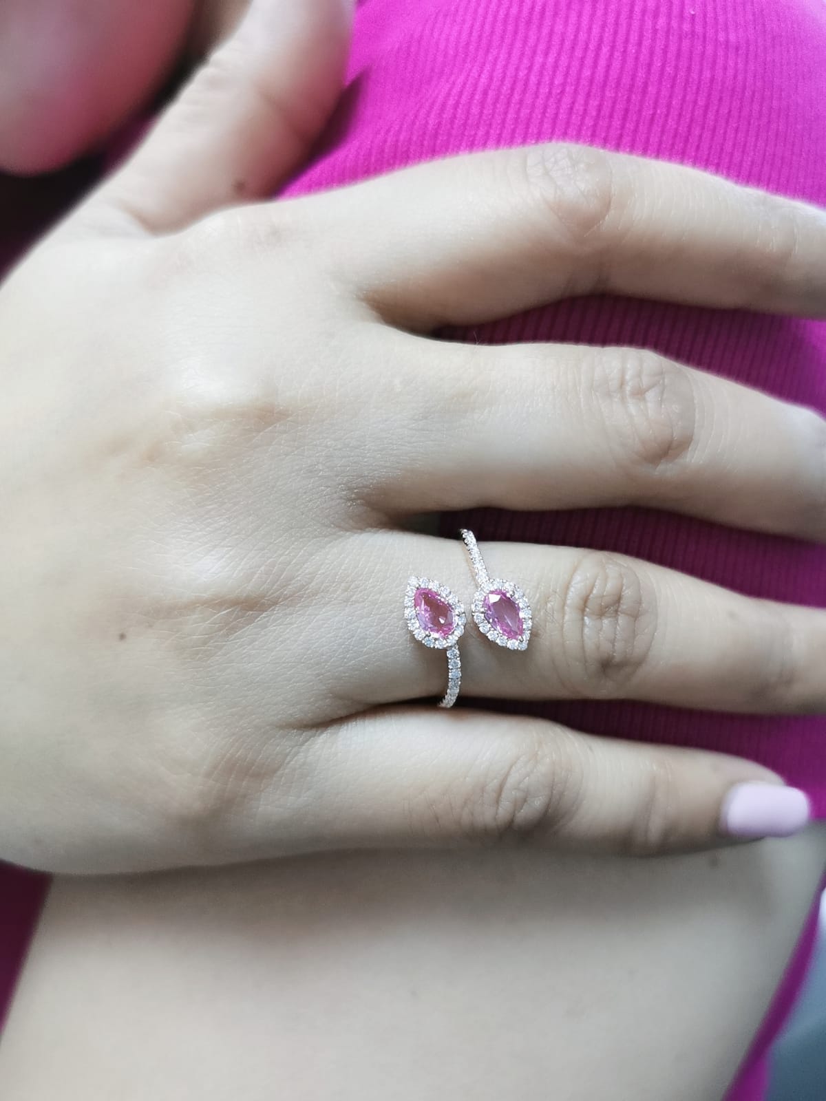 Toi et Moi ring in 18K rose gold with 1.44ct pear-shaped pink sapphires and 0.34ct diamond halo on a pavé band.