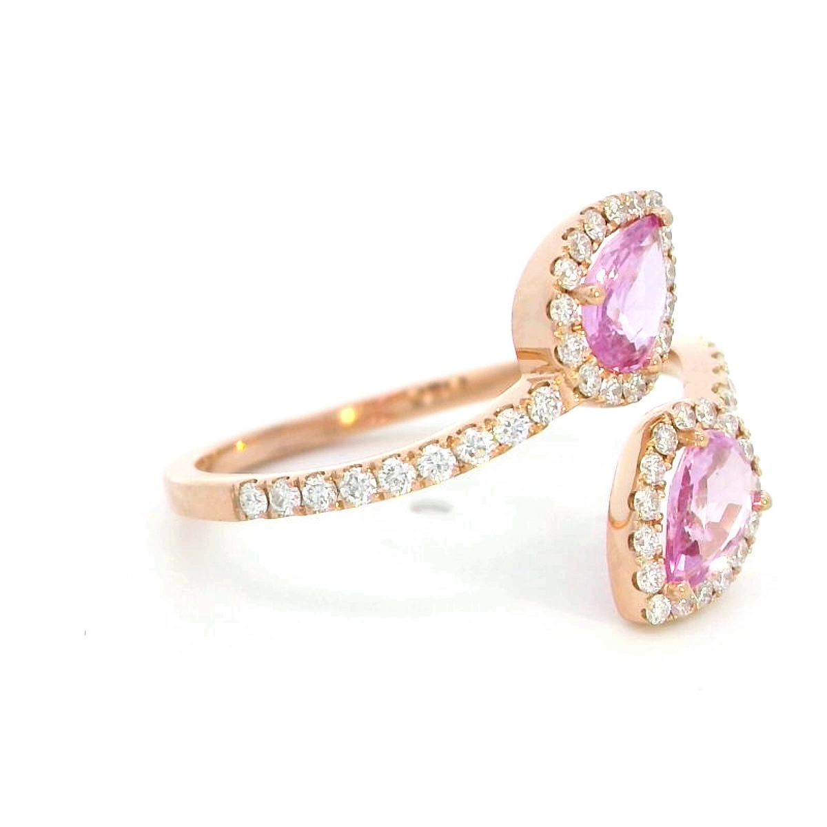 Toi et Moi ring in 18K rose gold with 1.44ct pear-shaped pink sapphires and 0.34ct diamond halo on a pavé band.
