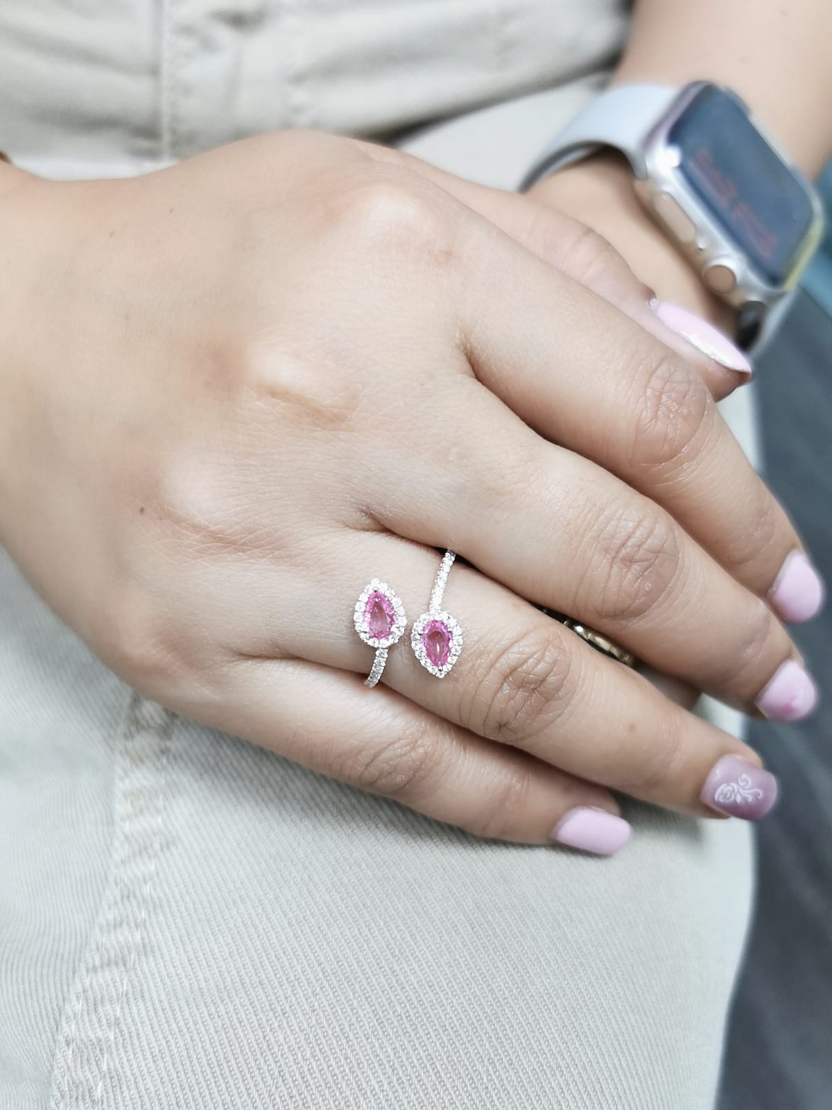 Toi et Moi ring in 18K rose gold with 1.44ct pear-shaped pink sapphires and 0.34ct diamond halo on a pavé band.