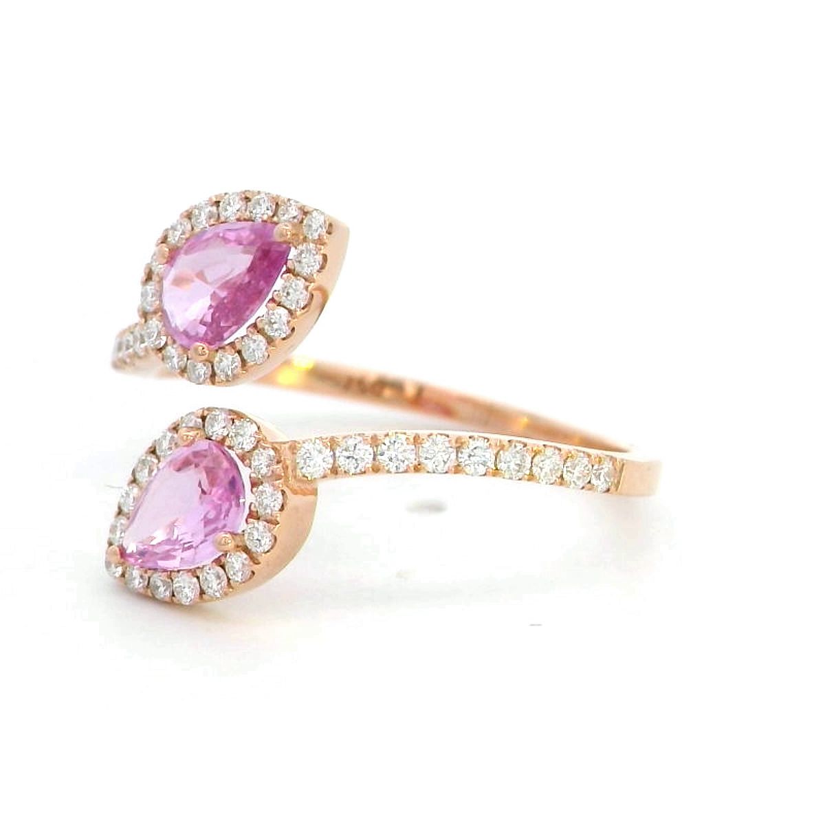 Toi et Moi ring in 18K rose gold with 1.44ct pear-shaped pink sapphires and 0.34ct diamond halo on a pavé band.