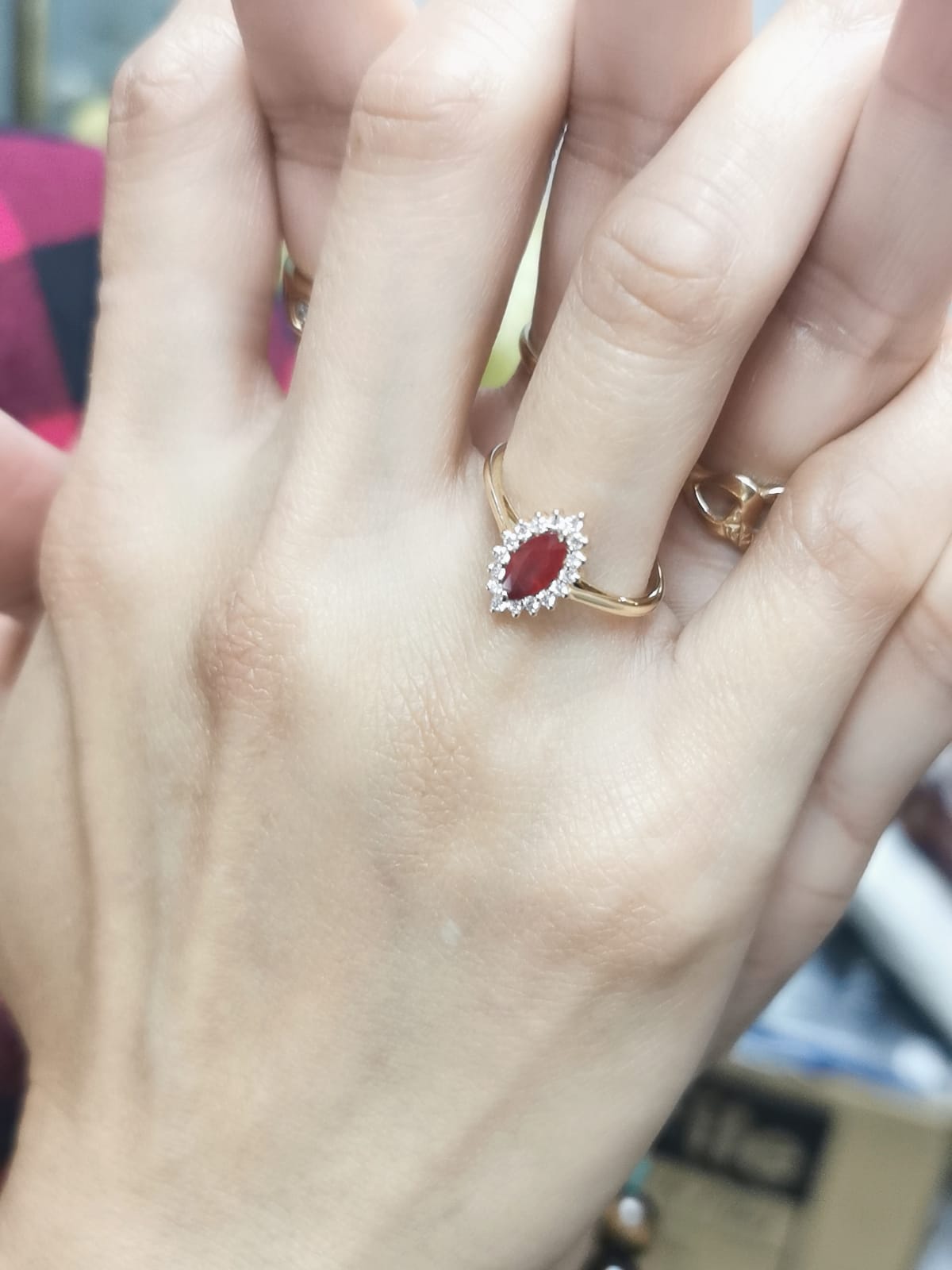 18K yellow gold marquise ruby ring with diamond halo"