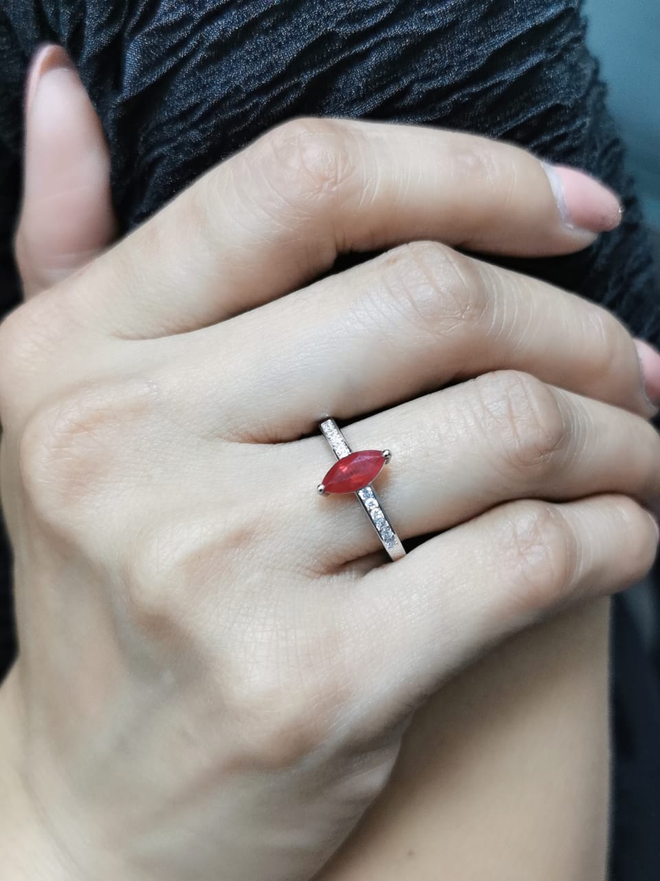 18K white gold marquise ruby and diamond ring featuring a 0.97-carat ruby and 0.21 carats of diamonds, symbolizing the July birthstone.