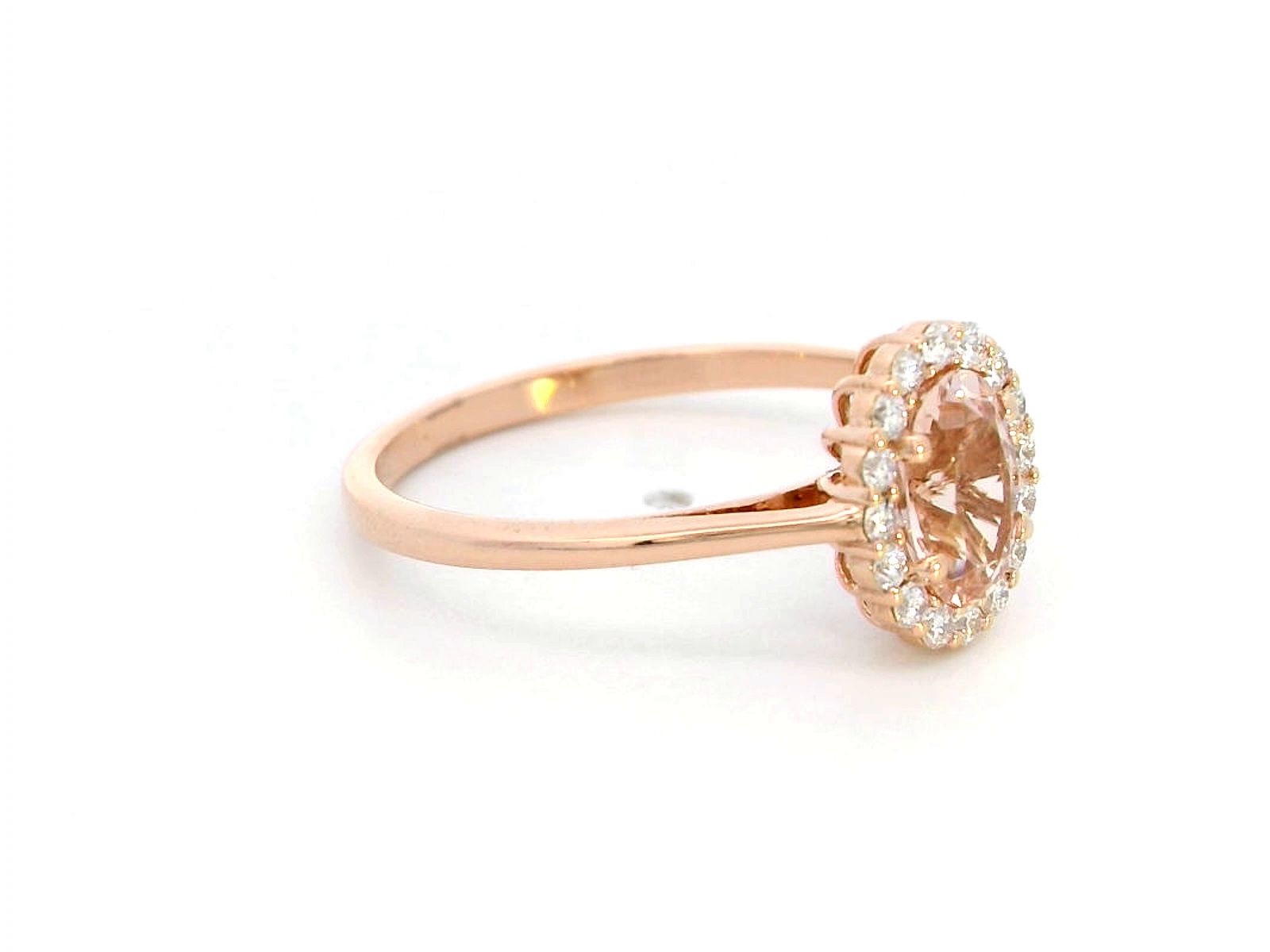 18K rose gold ring featuring a 0.64-carat oval peachy pink morganite, surrounded by a sparkling diamond halo with a total weight of 0.17 carats, showcasing an elegant and polished design.