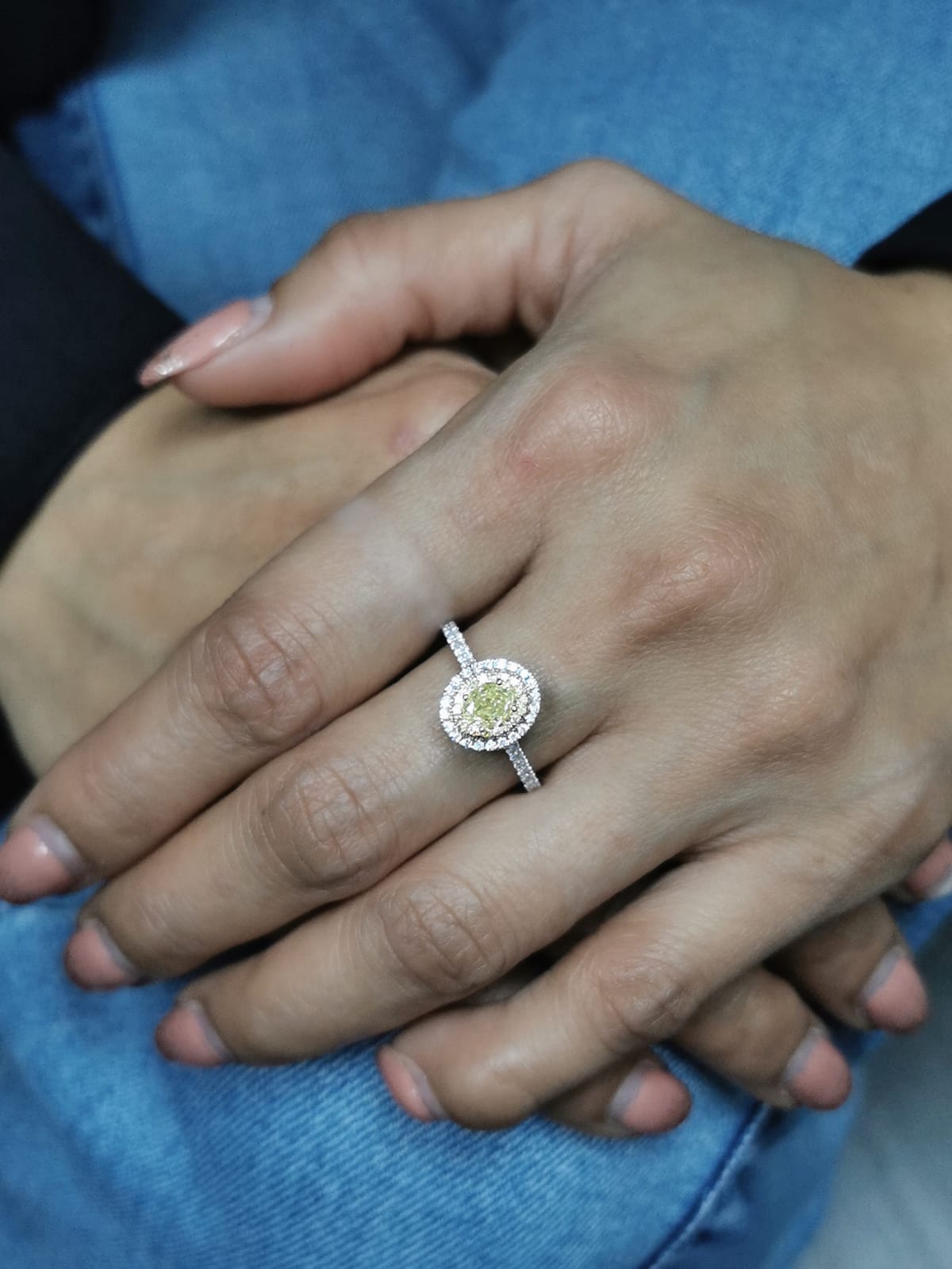 1.07ct fancy yellow diamond halo engagement ring with a radiant-cut center stone, double diamond halo, and pavé band in 18K gold.