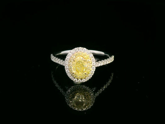1.07ct fancy yellow diamond halo engagement ring with a radiant-cut center stone, double diamond halo, and pavé band in 18K gold.