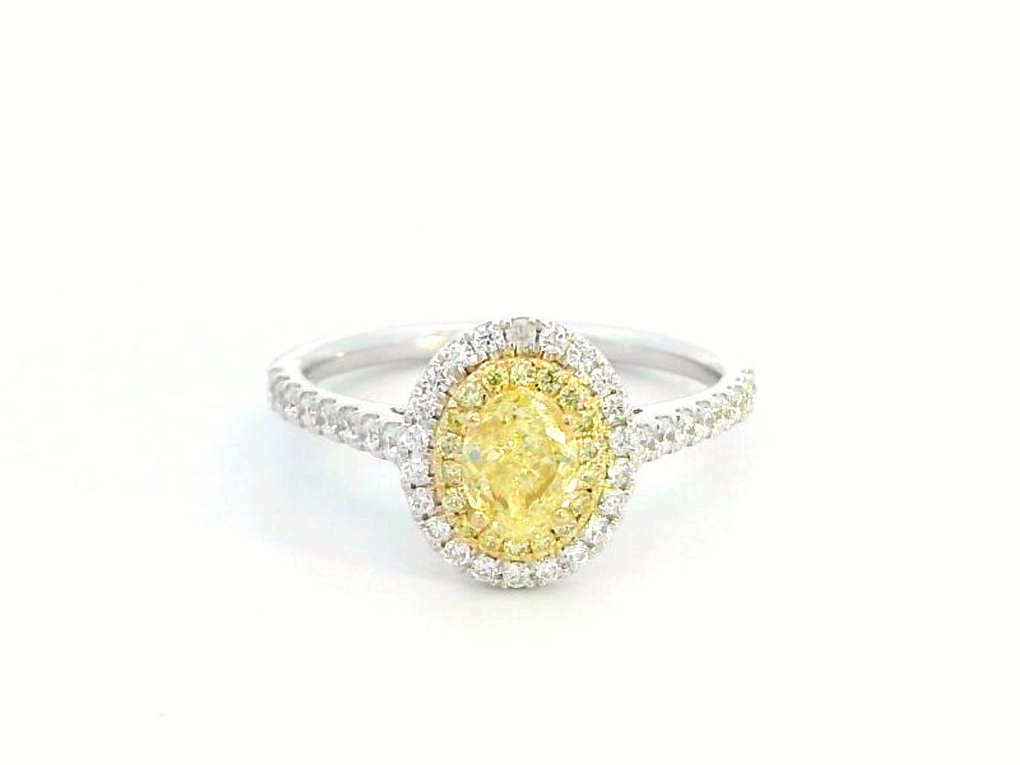 1.07ct fancy yellow diamond halo engagement ring with a radiant-cut center stone, double diamond halo, and pavé band in 18K gold.