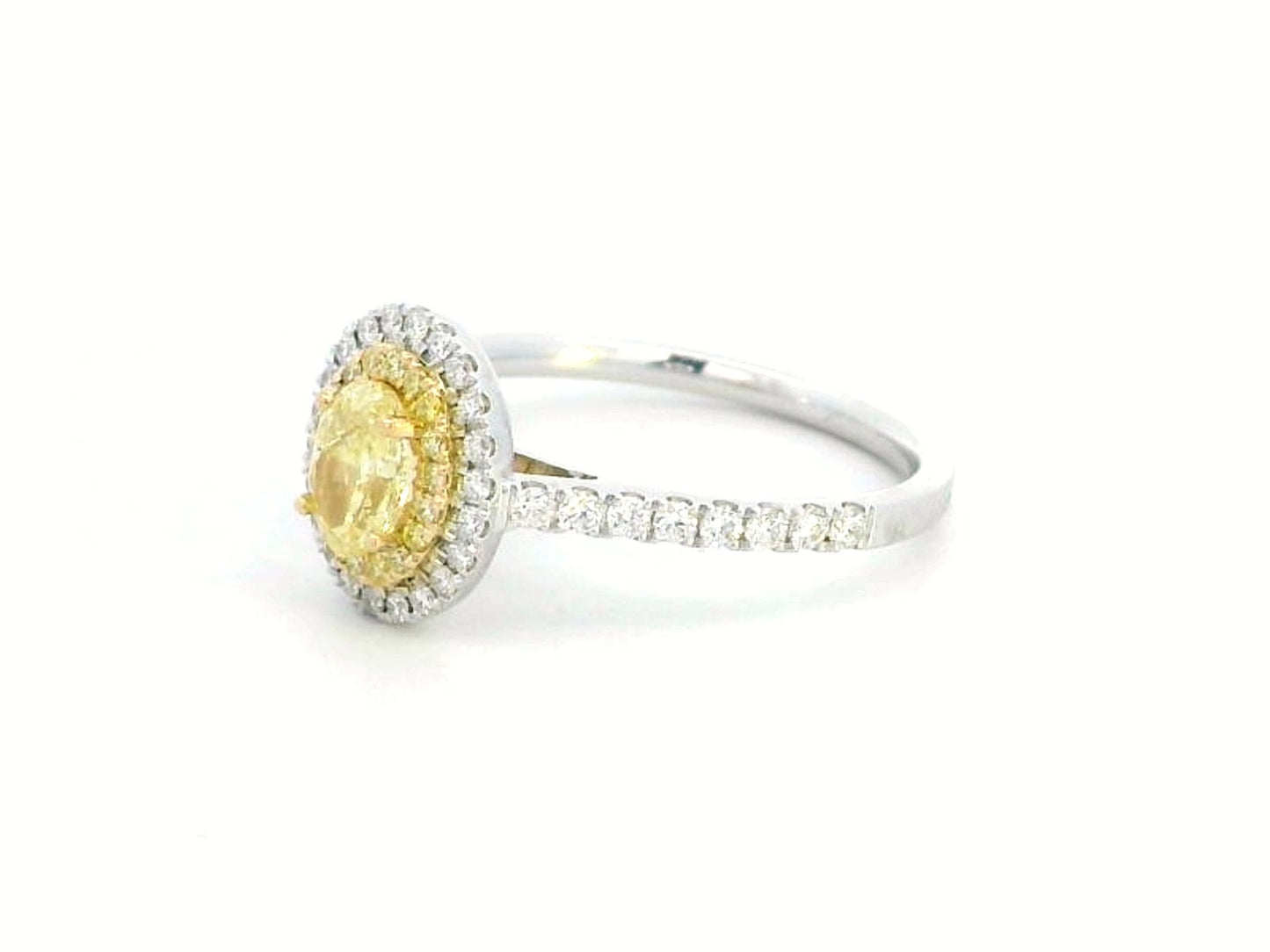 1.07ct fancy yellow diamond halo engagement ring with a radiant-cut center stone, double diamond halo, and pavé band in 18K gold.