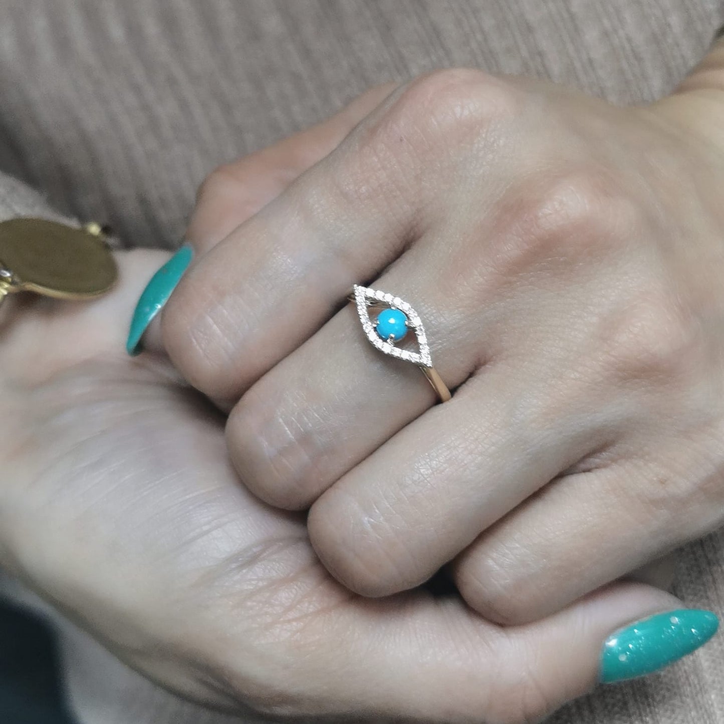 18K gold Evil Eye ring featuring a 0.32-carat turquoise center stone with a 0.15-carat diamond halo. Symbolic and stylish, perfect for stacking.