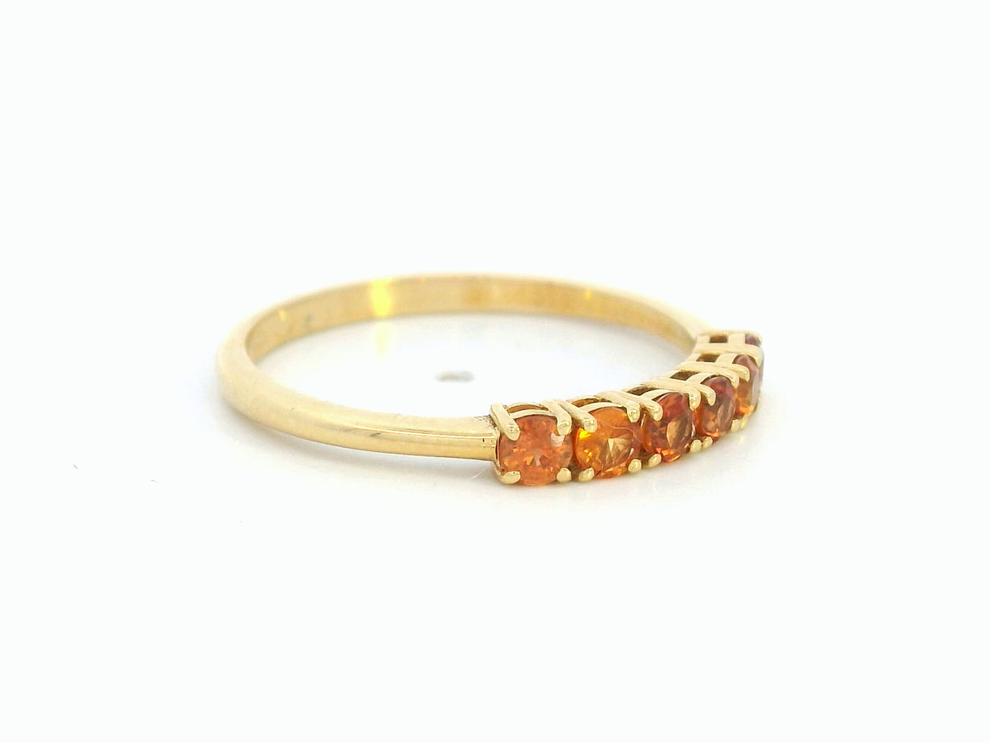 18K yellow gold ring with six round-cut orange sapphires in a half eternity setting