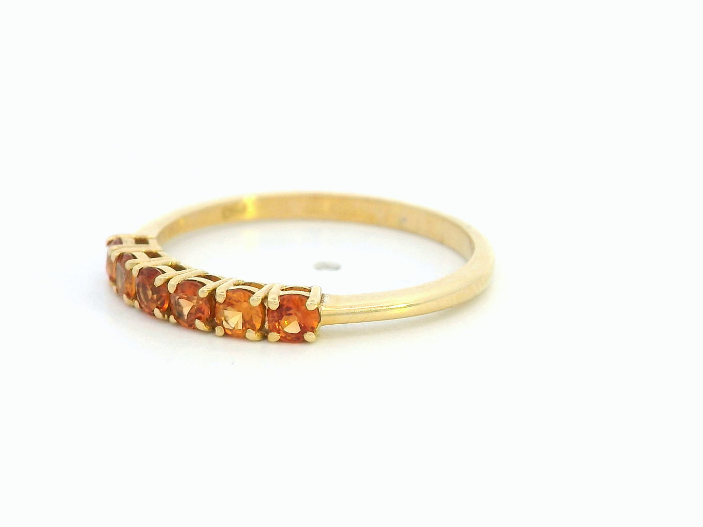 18K yellow gold ring with six round-cut orange sapphires in a half eternity setting