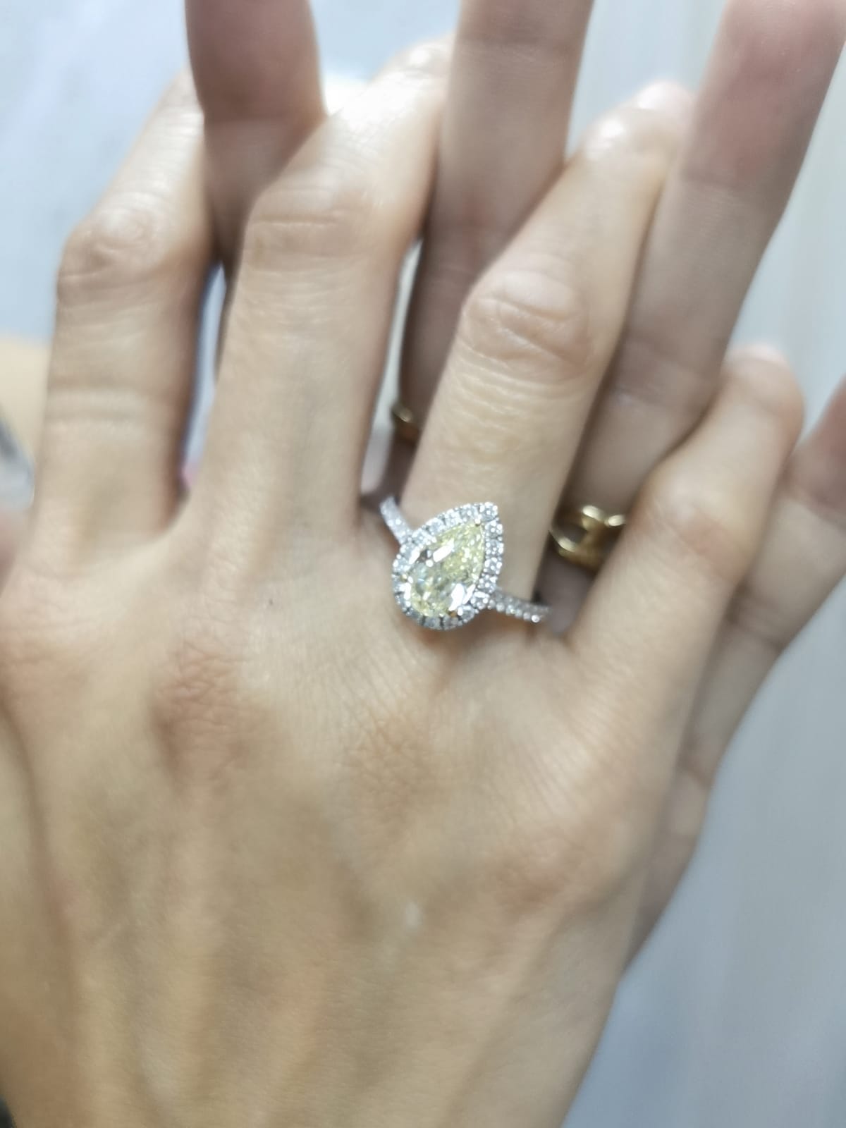 18K white gold ring with IGI certified 2.15ct pear-shaped fancy yellow diamond and 0.50ct white diamond halo