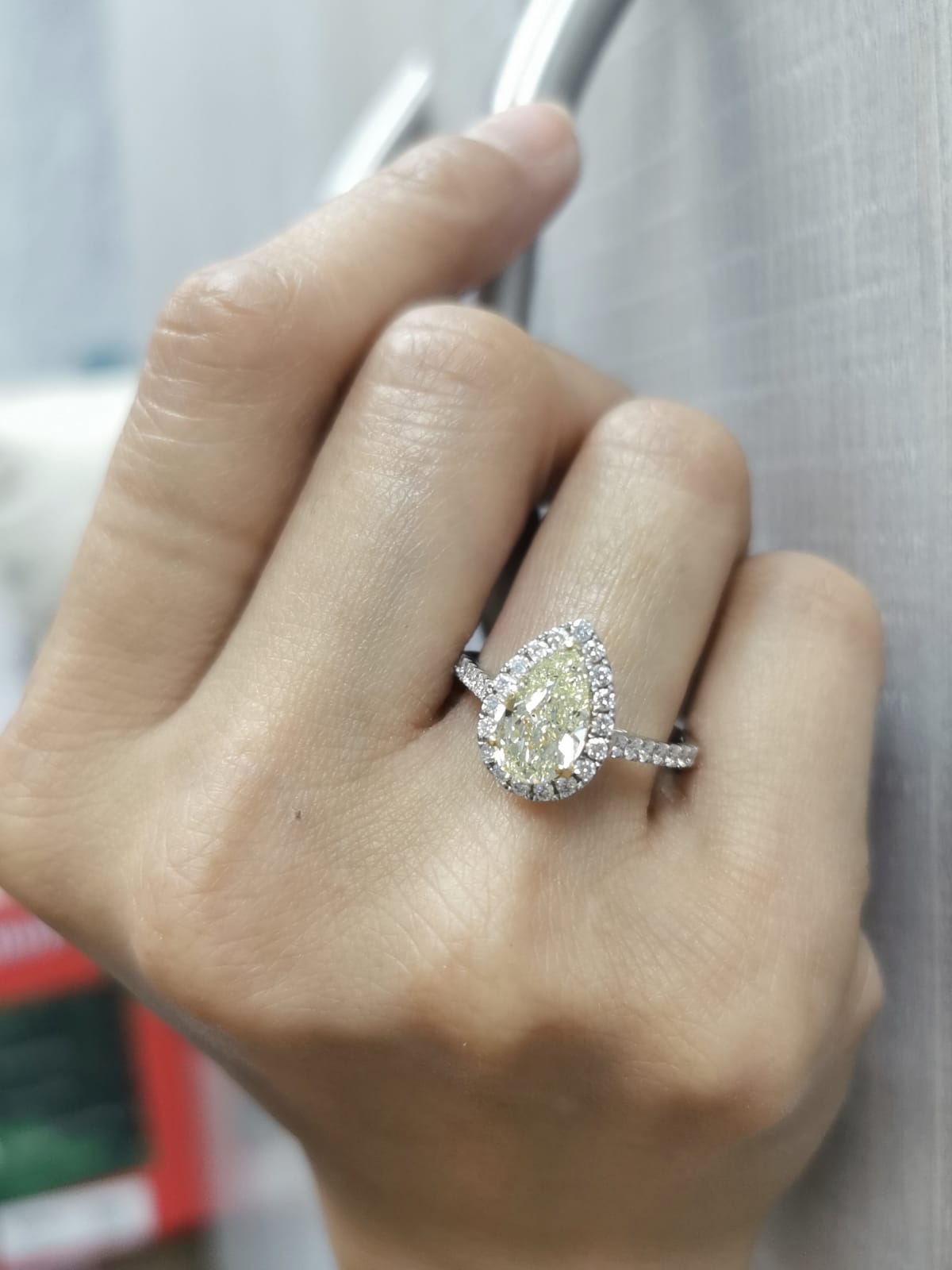 18K white gold ring with IGI certified 2.15ct pear-shaped fancy yellow diamond and 0.50ct white diamond halo