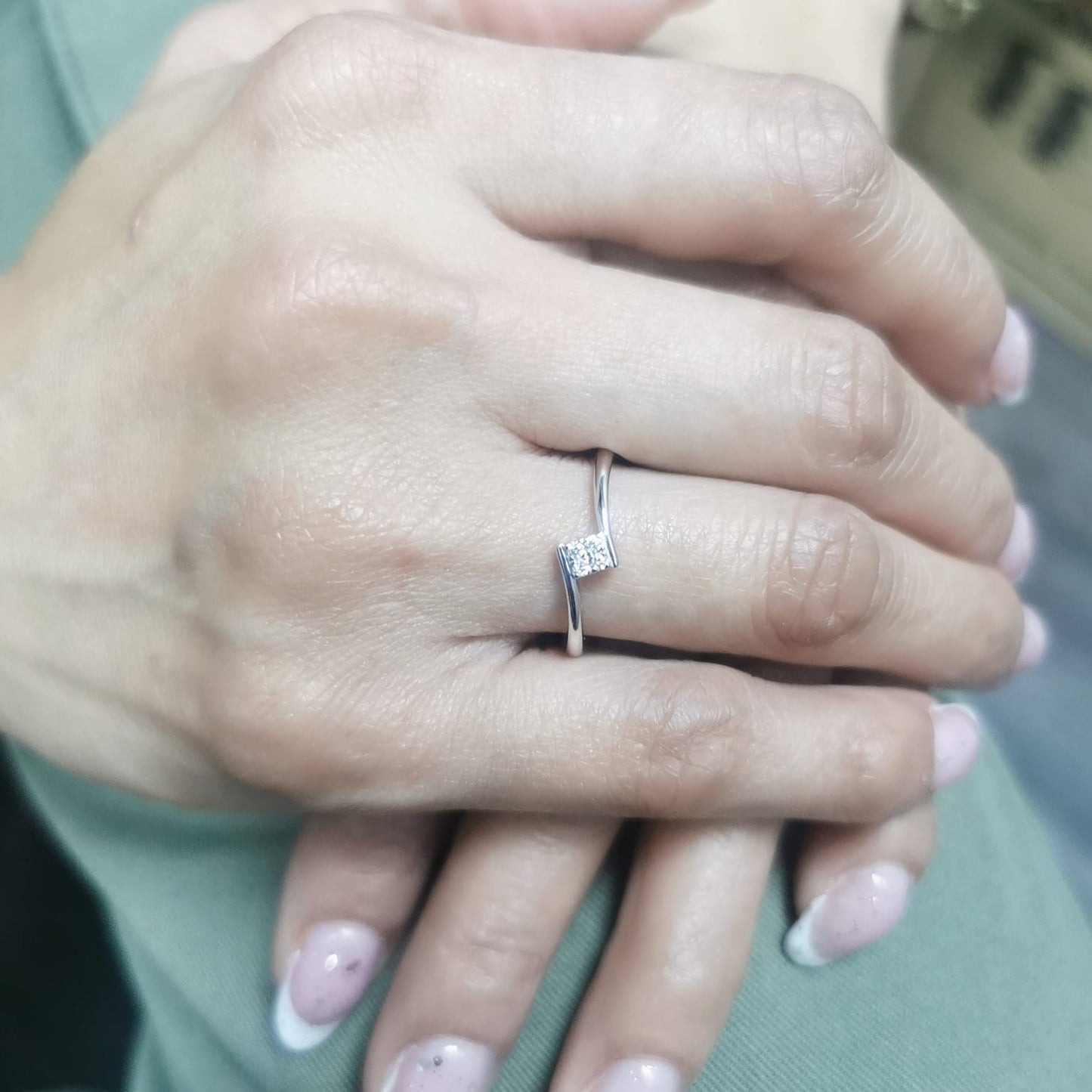 Minimalist 18K gold bypass ring with 0.06 carat total diamond weight, featuring a sleek modern design and geometric diamond setting.