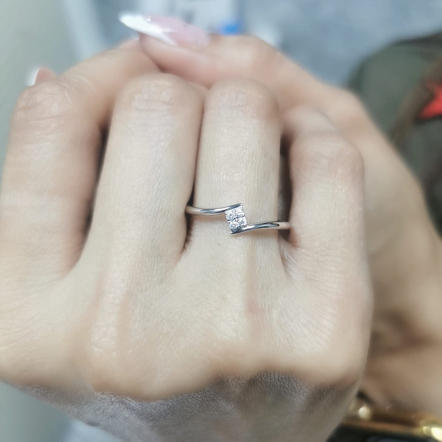 Minimalist 18K gold bypass ring with 0.06 carat total diamond weight, featuring a sleek modern design and geometric diamond setting.