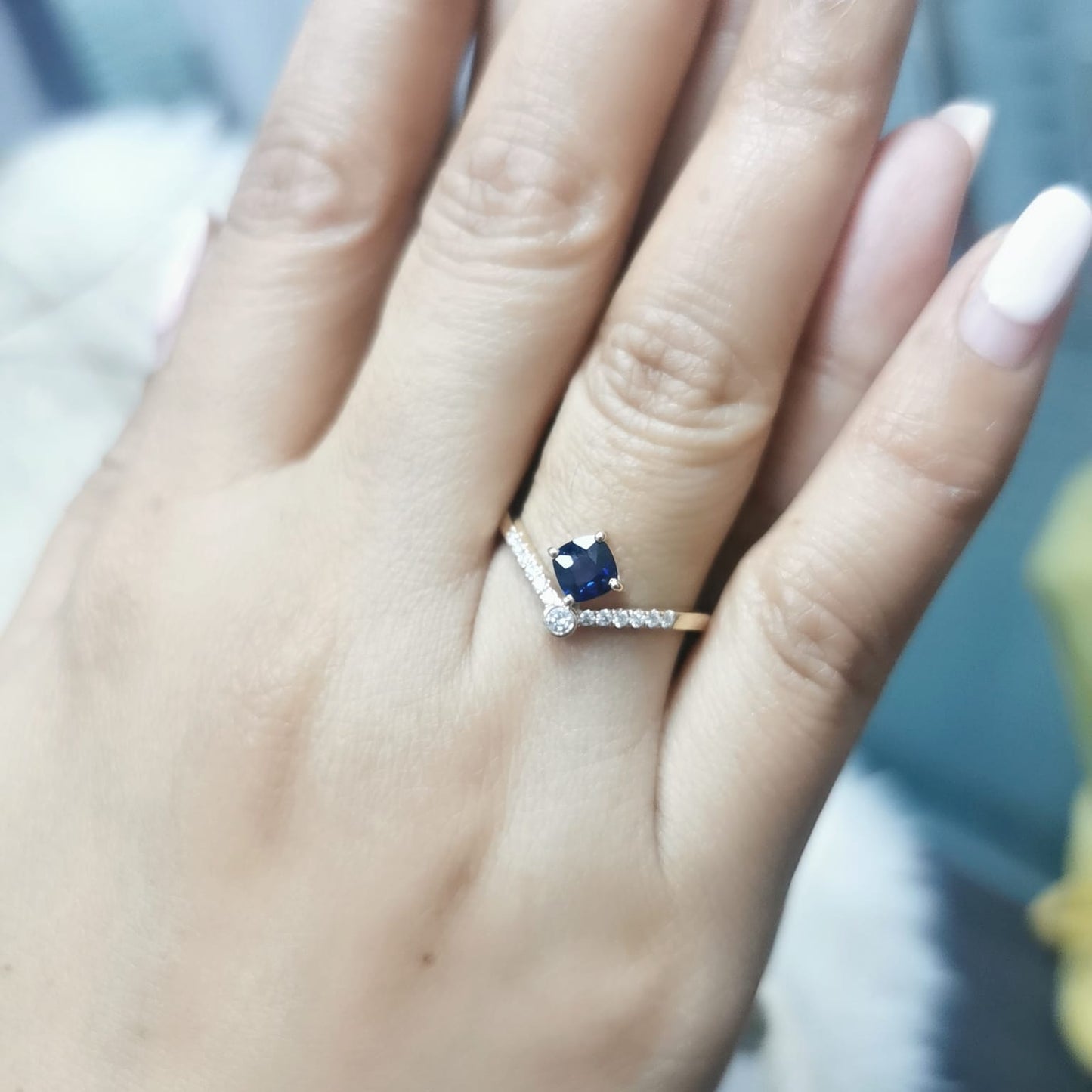 18K gold blue sapphire and diamond ring featuring a 0.51 carat cushion-cut sapphire and 0.14 carats of round-cut diamonds, set in an elegant design. Perfect for special occasions and fine jewelry lovers