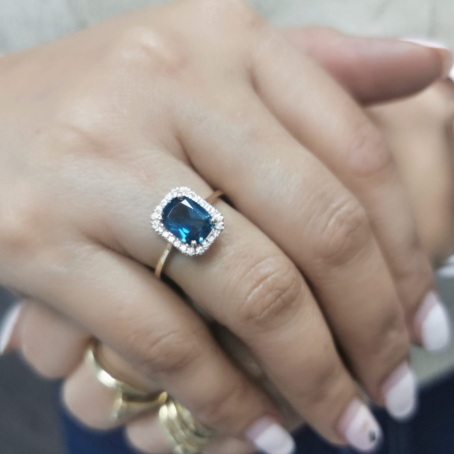 Emerald-cut 2.25-carat London Blue Topaz ring with 0.19-carat diamond accents in 18K yellow gold