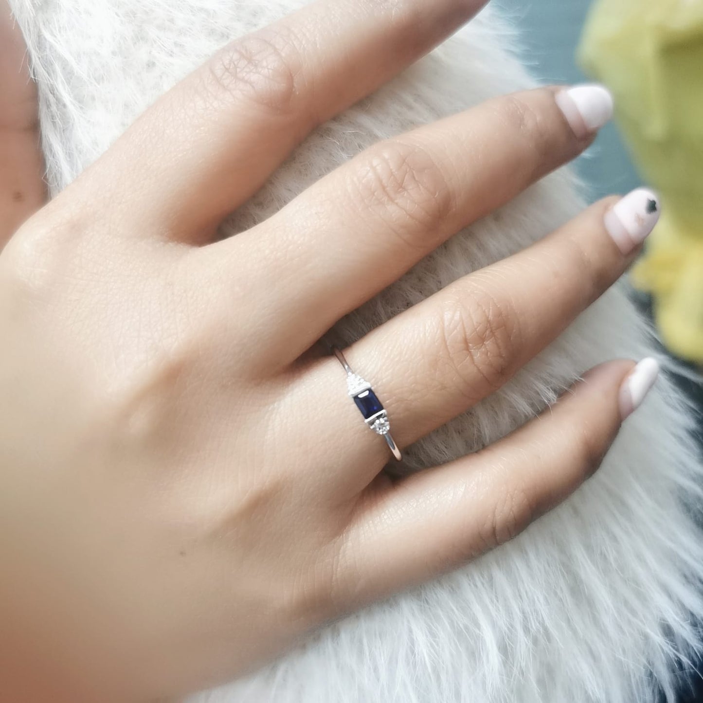 18K gold ring with a baguette-cut blue sapphire (0.26 carats) and round-cut diamonds (0.08 carats), bezel-set on a slim band—perfect for stacking or wearing alone.