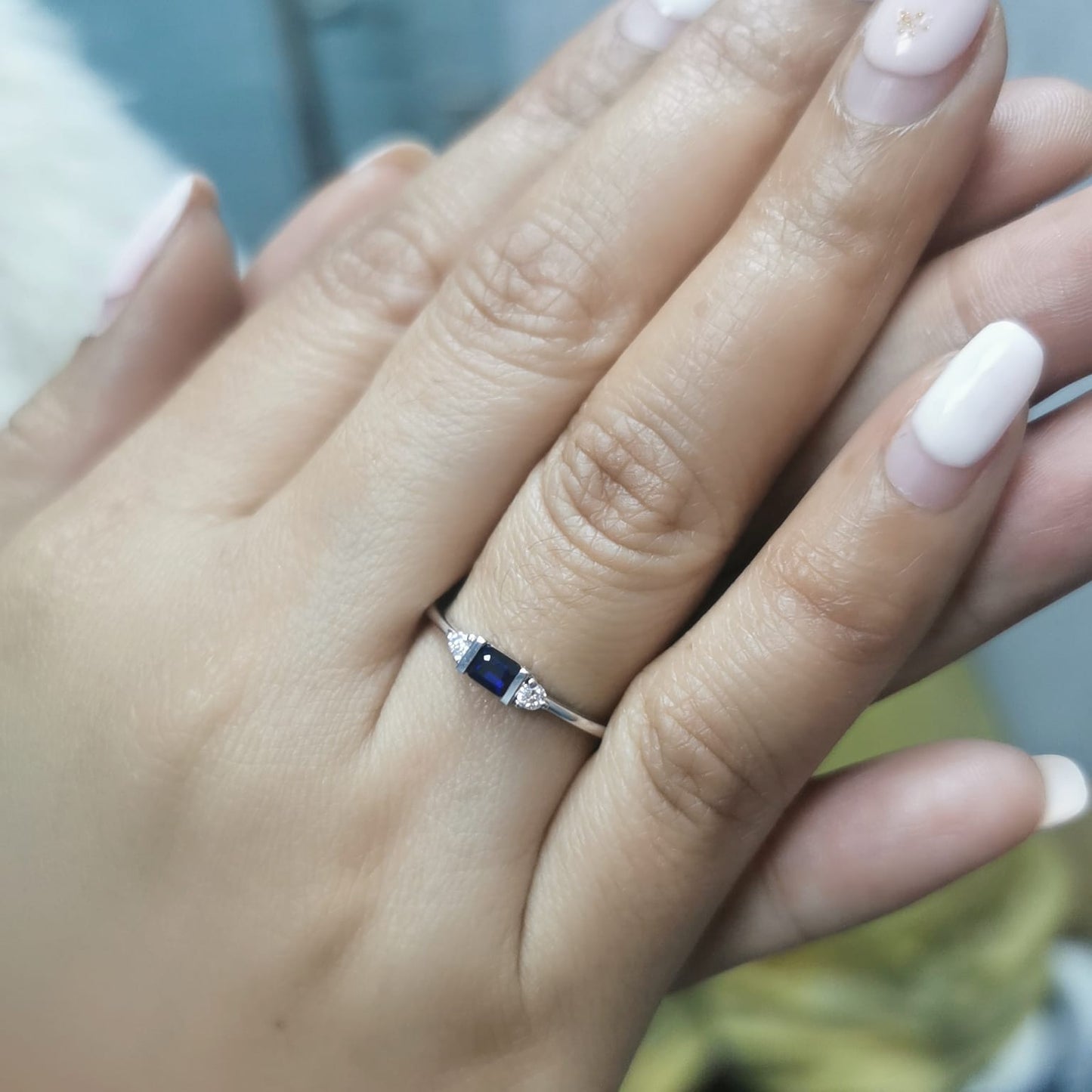 18K gold ring with a baguette-cut blue sapphire (0.26 carats) and round-cut diamonds (0.08 carats), bezel-set on a slim band—perfect for stacking or wearing alone.