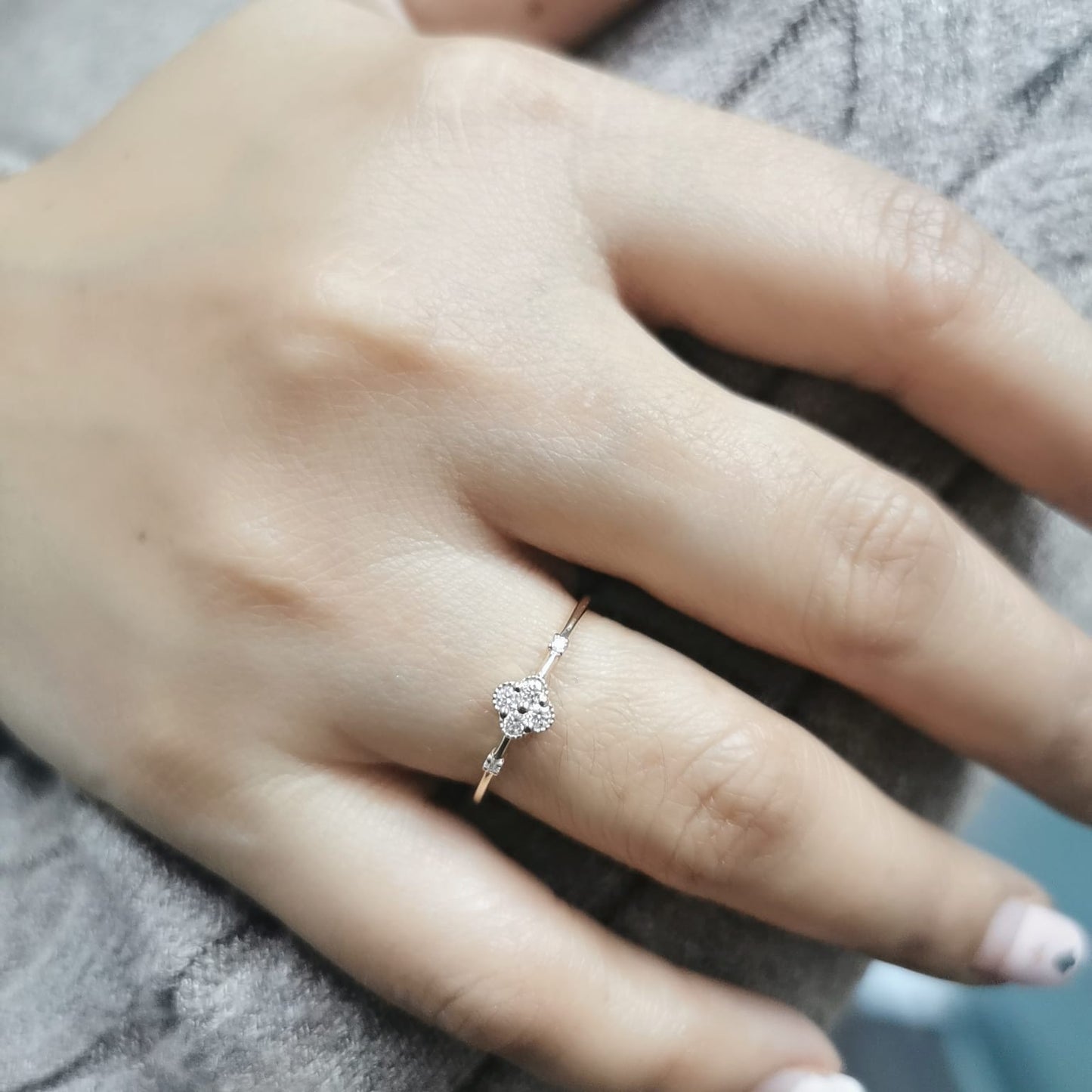 Minimalist 18K gold diamond clover ring with 0.12 carat total weight, featuring a delicate band and modern, elegant design.