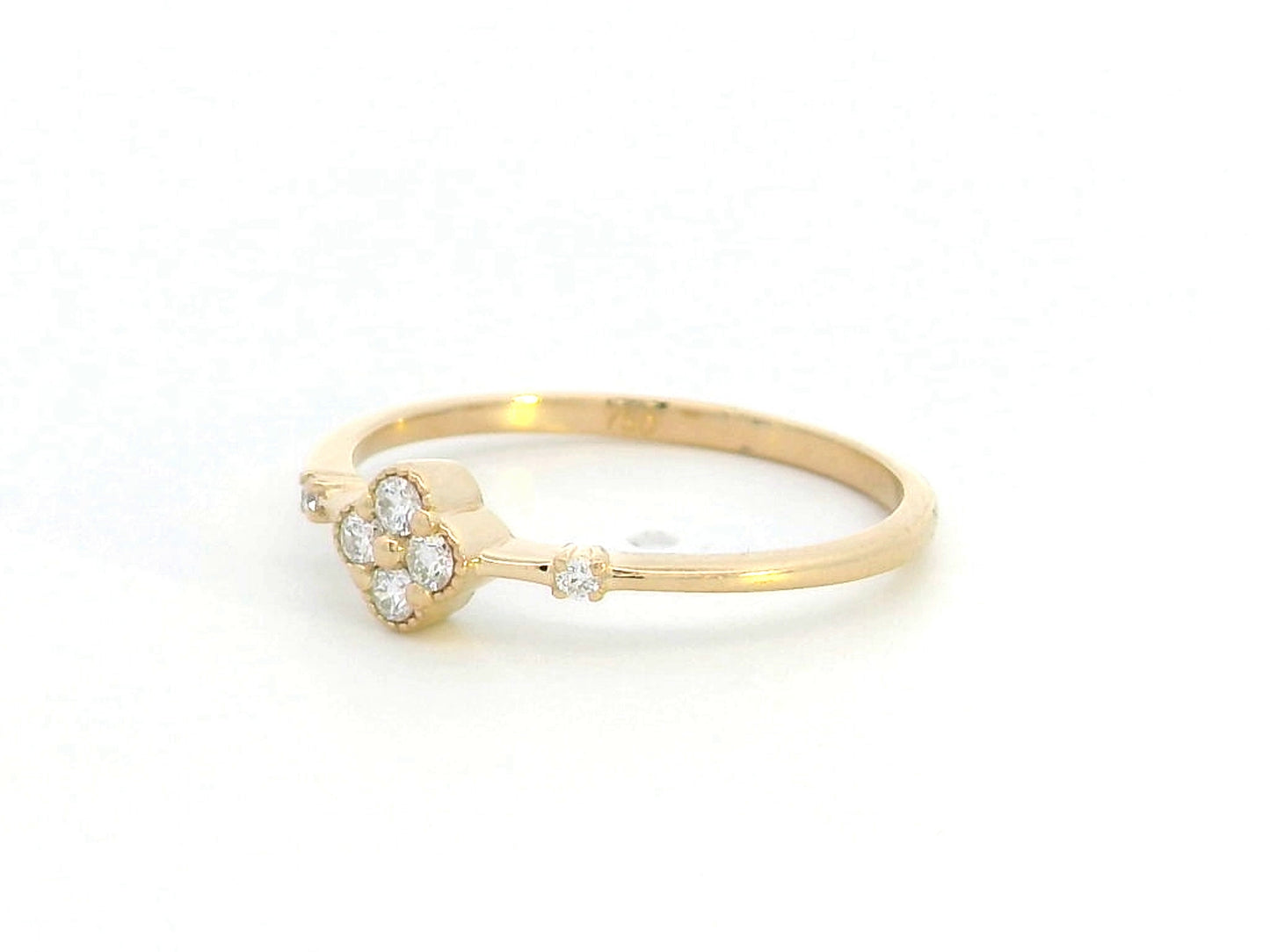 Minimalist 18K gold diamond clover ring with 0.12 carat total weight, featuring a delicate band and modern, elegant design.