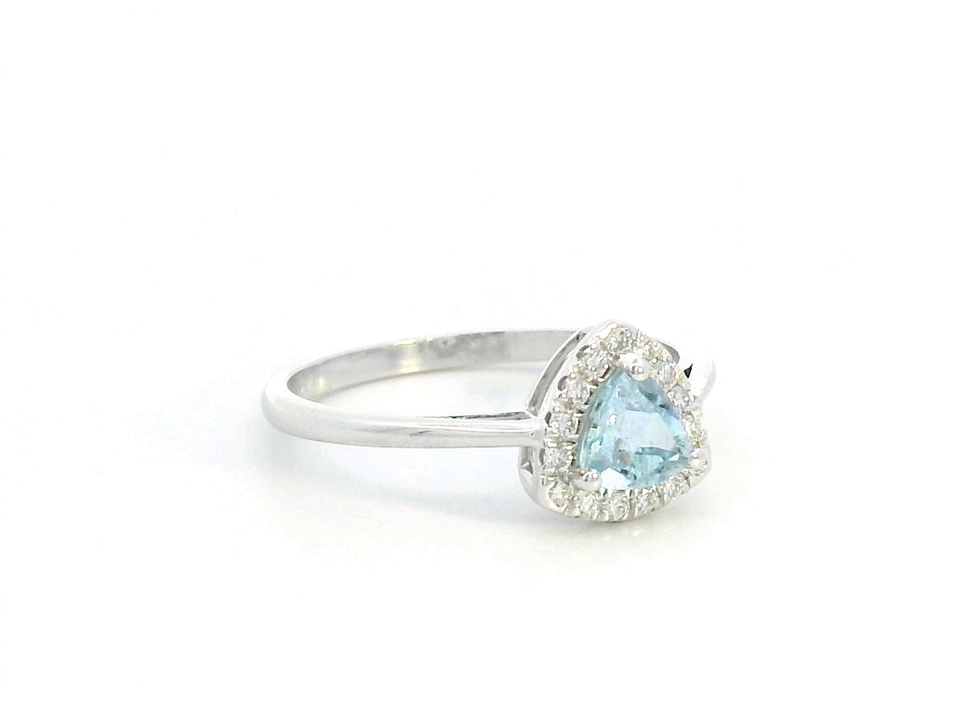 Trillion-cut aquamarine and diamond halo ring in 18K white gold, featuring a 0.50-carat aquamarine center stone surrounded by 0.15-carat diamonds.