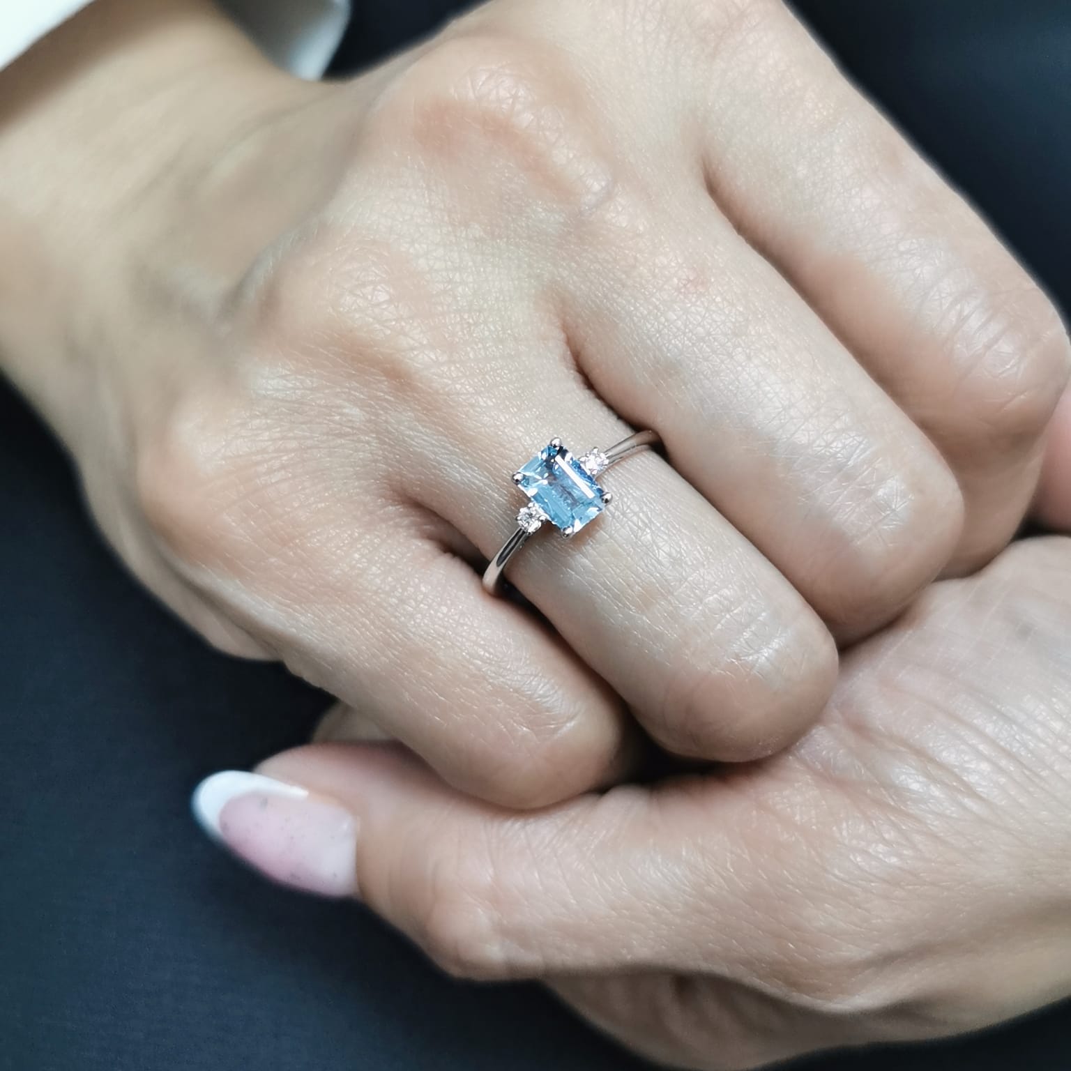 18K white gold aquamarine and diamond ring featuring a 0.65-carat emerald-cut aquamarine with 0.07-carat round diamonds in a minimalist fine jewelry design – perfect for engagements, gifts, and March birthstone jewelry.