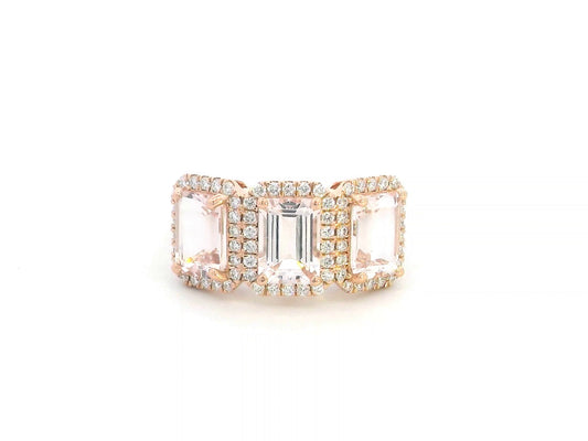 8K rose gold three-stone morganite and diamond ring featuring 2.79 carats of emerald-cut morganite with 0.38 carats of brilliant diamonds in a halo setting. A perfect statement or anniversary ring
