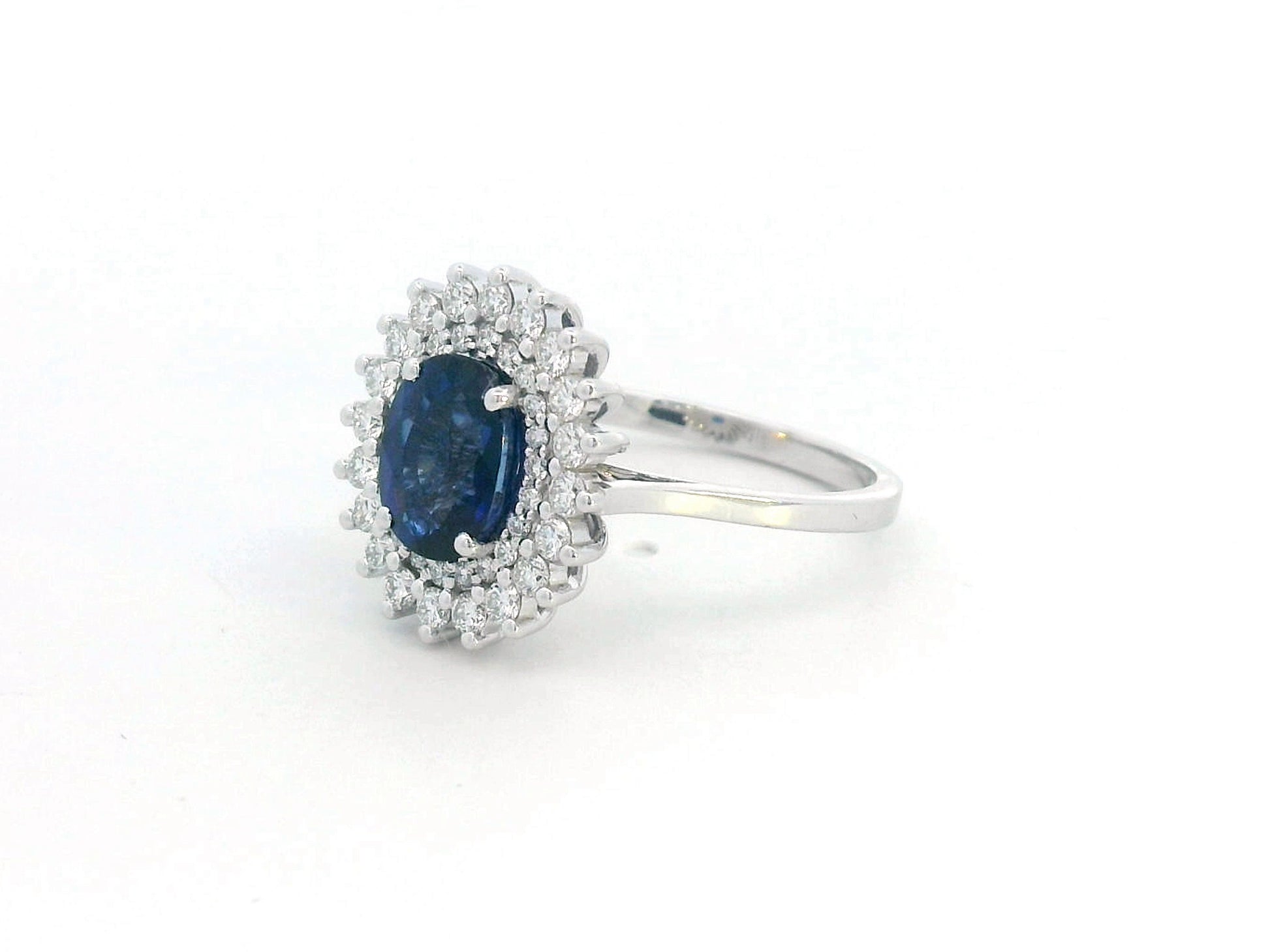 Elegant 2.00 carat sapphire halo ring with 0.53 carats of diamonds, set in 18K white gold. Classic halo design enhances brilliance—perfect as a September birthstone ring.