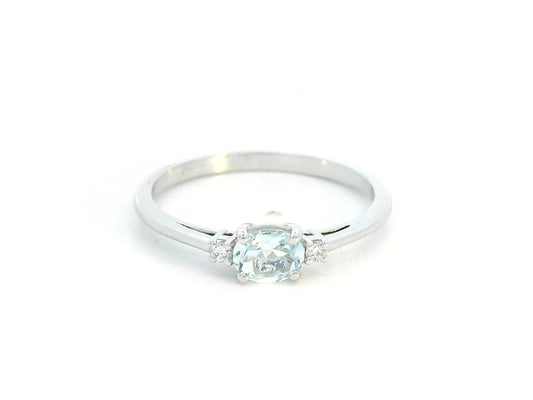 Minimalist oval aquamarine and diamond ring in 18K gold – March birthstone ring.